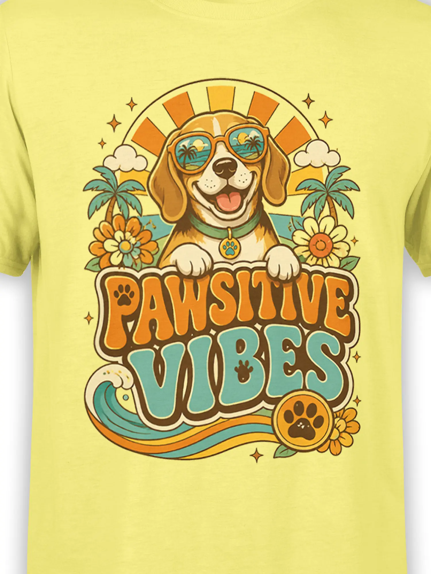 Close-up of Pawsitive Vibes dog design with sunglasses, sunburst, palm trees and wave on yellow shirt