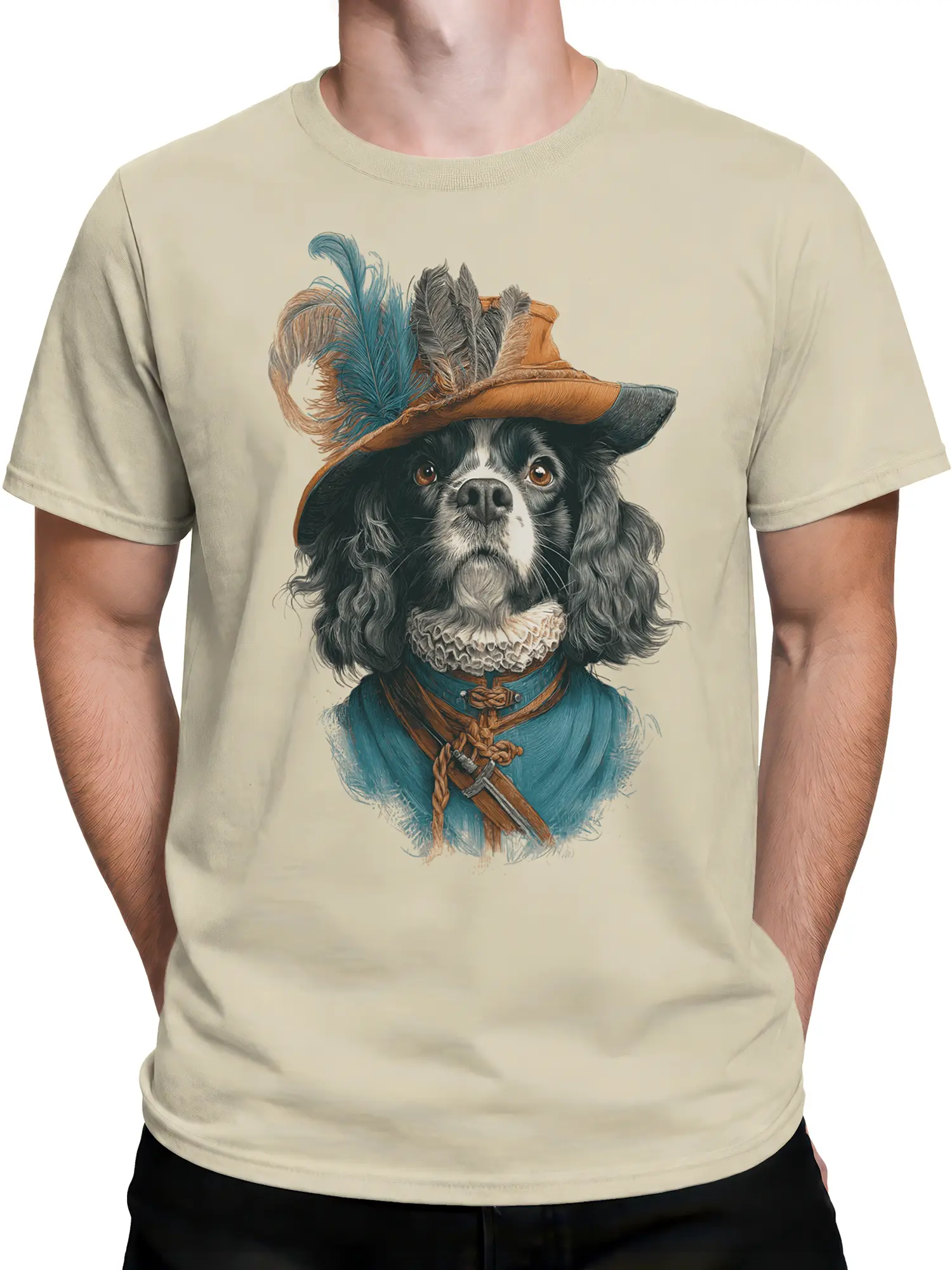 Man wearing beige musketeer spaniel dog t-shirt with spaniel in blue coat and feathered hat displayed across the chest