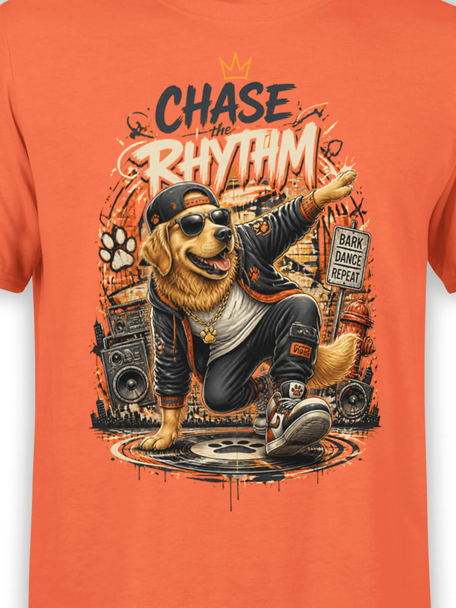 Close-up of Golden Retriever street dancer graphic with shades, cap, gold chain, and “Chase the Rhythm” graffiti text on orange fabric