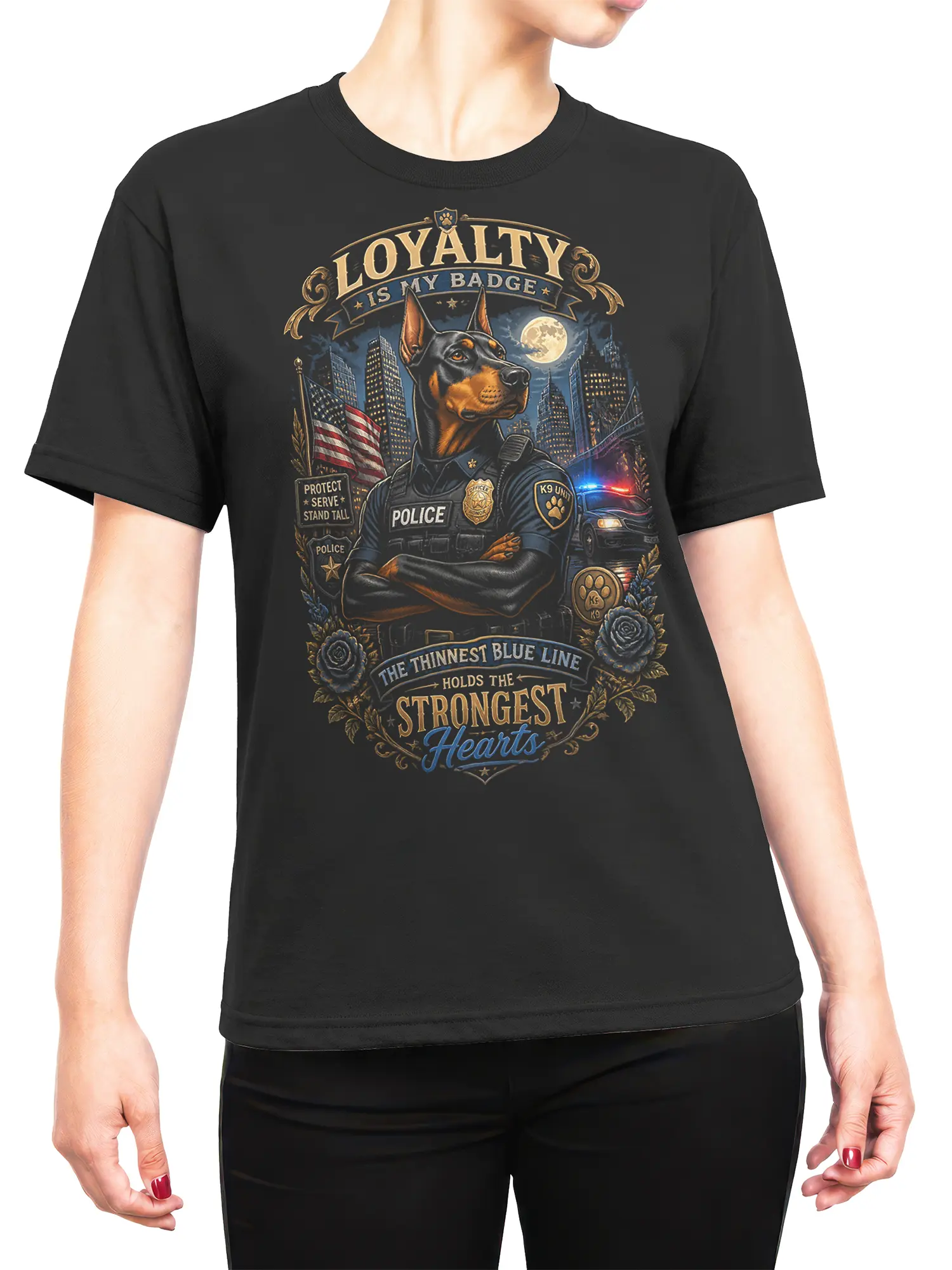 Woman wearing black Doberman K9 police T-shirt with loyalty quote and thin blue line city scene graphic.
