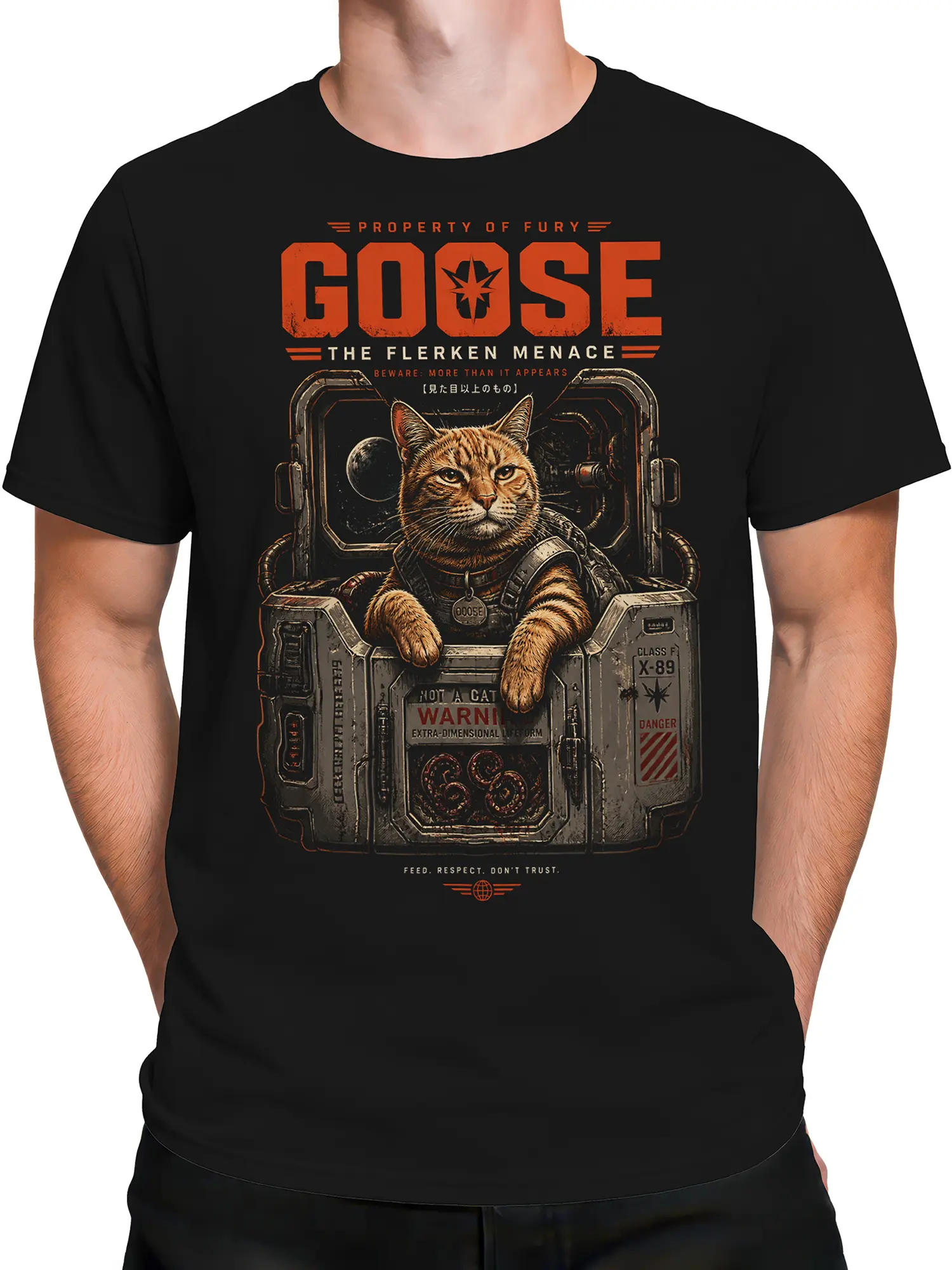 male model wearing black Goose space cat T-shirt featuring sci-fi containment pod and orange warning text