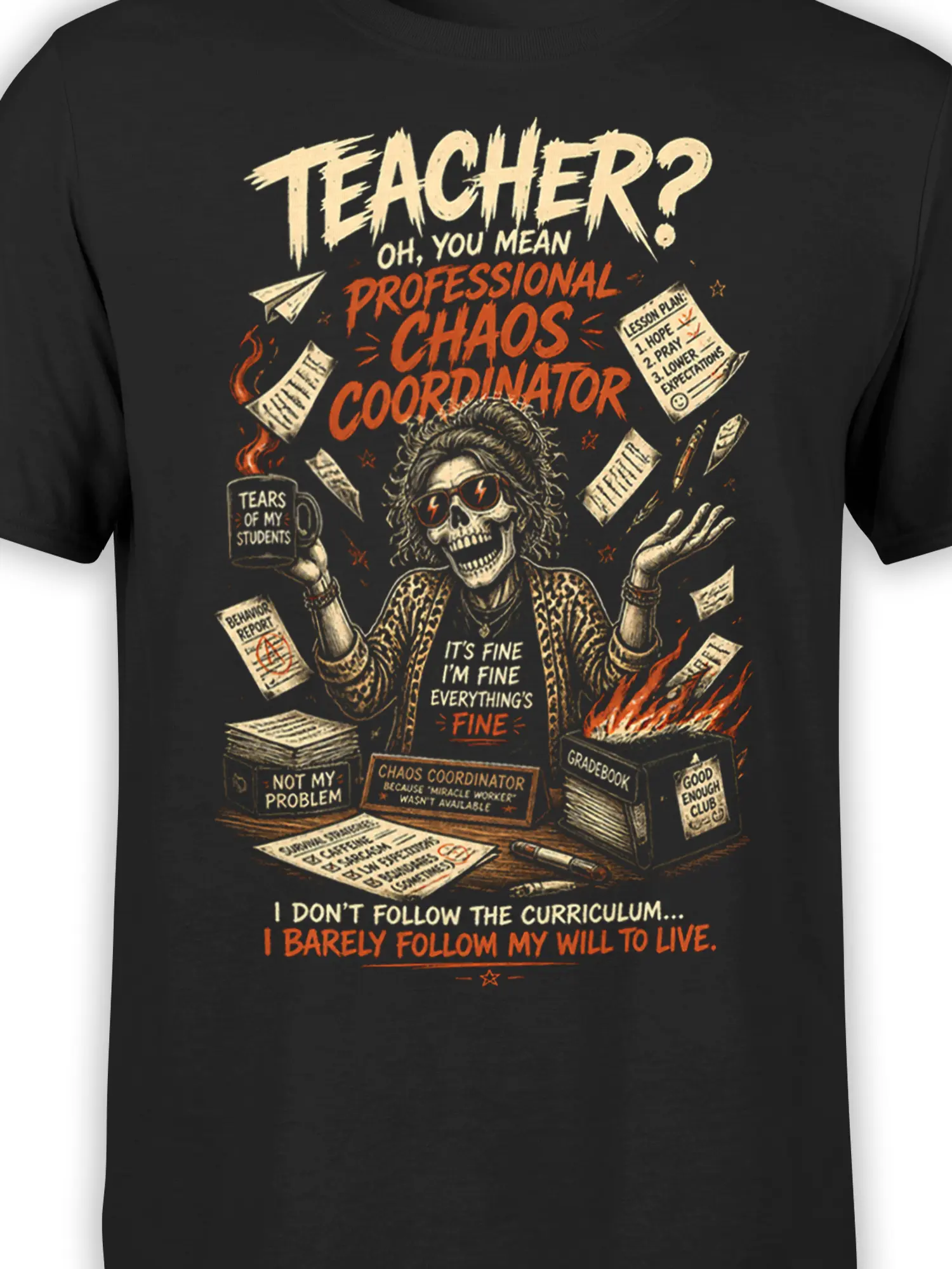 Close-up of black teacher shirt artwork with skull educator, “Professional Chaos Coordinator,” and classroom details