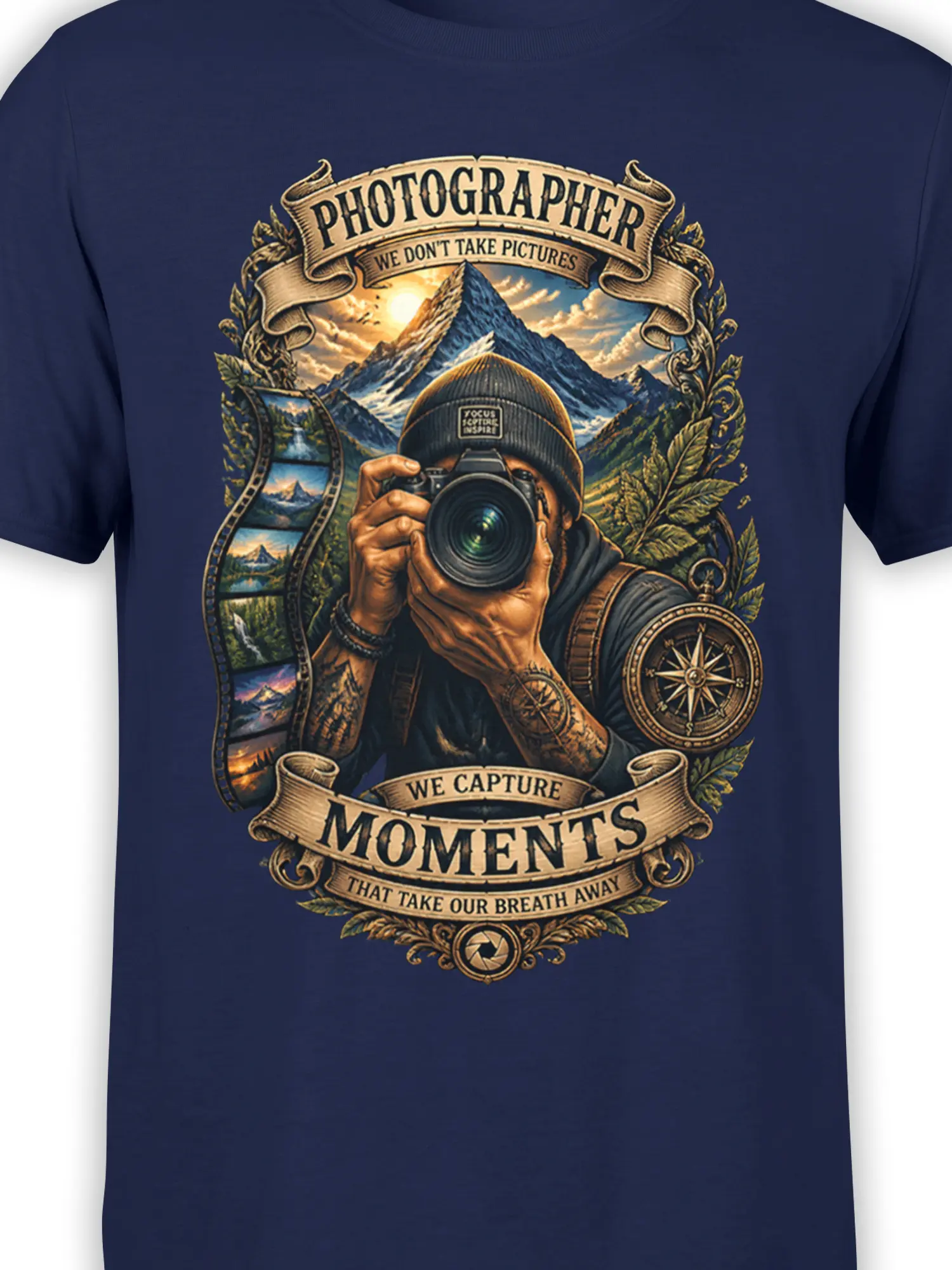 Close-up of photographer camera graphic, mountain peaks, compass, film strip, and text on navy fabric