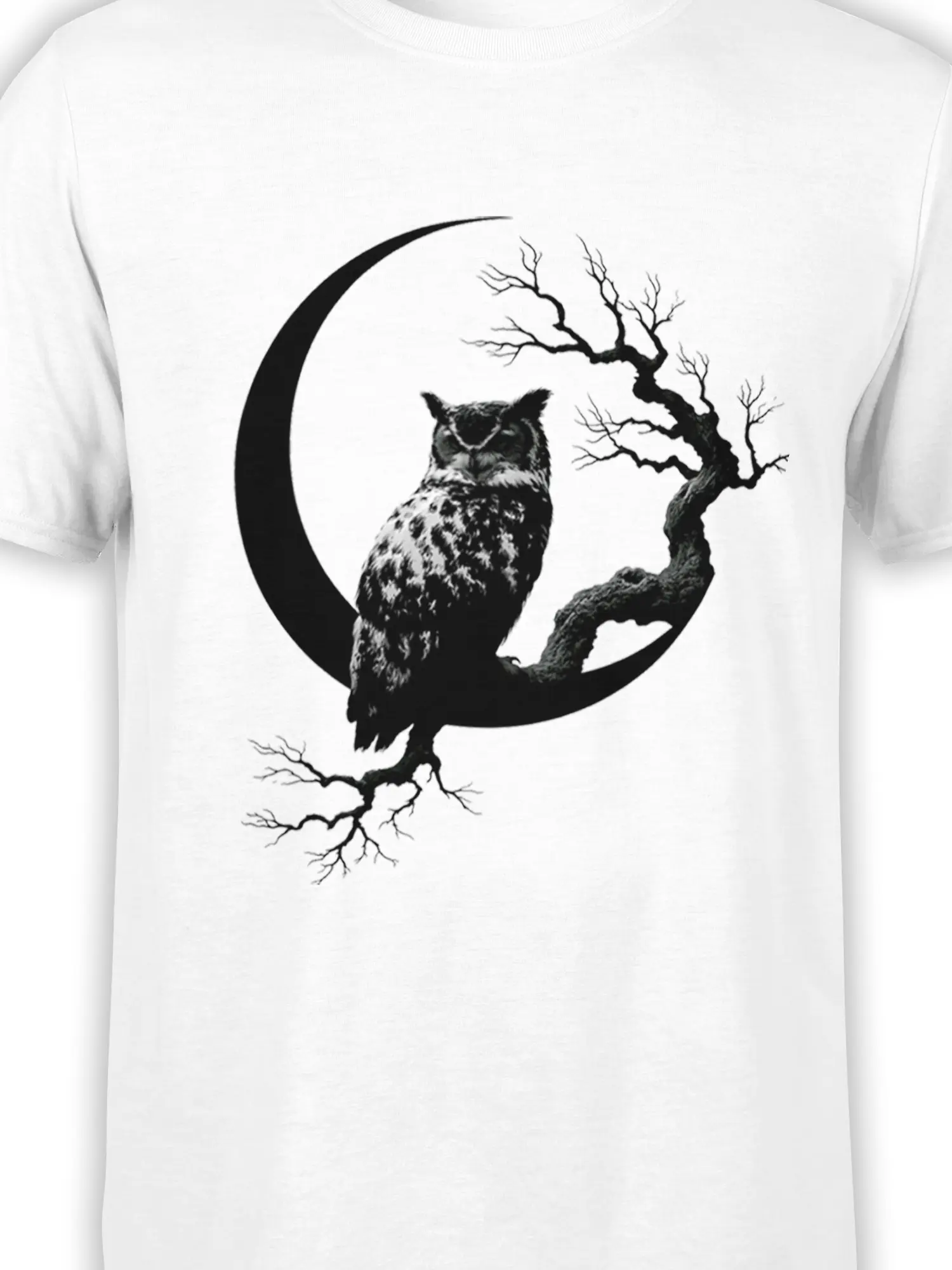 Close-up of black owl, crescent moon, and bare tree artwork printed on a white T-shirt