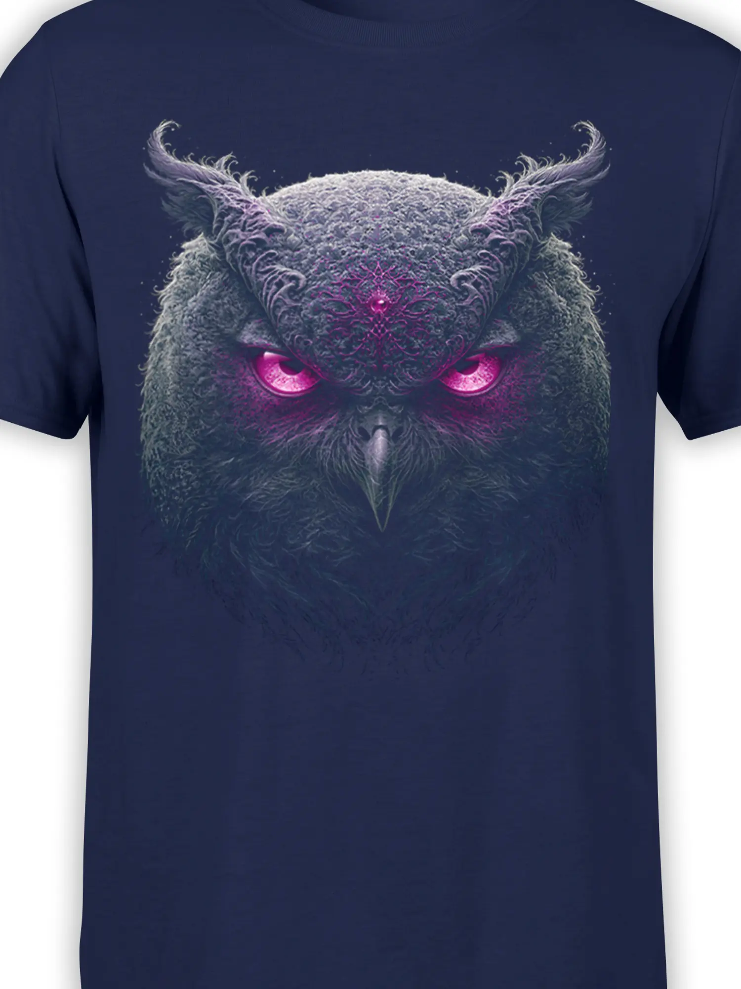 Close-up of ornate owl artwork with glowing magenta eyes on navy fabric