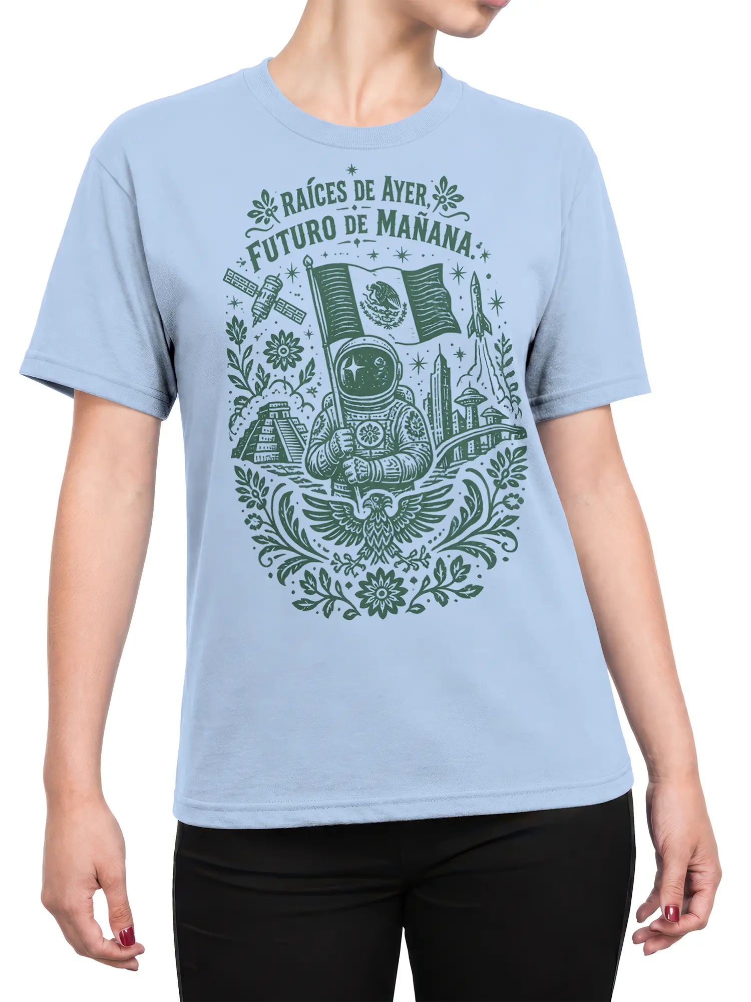 Female torso wearing a light blue T-shirt with a Mexican astronaut, rocket, flag, pyramid, and future city design