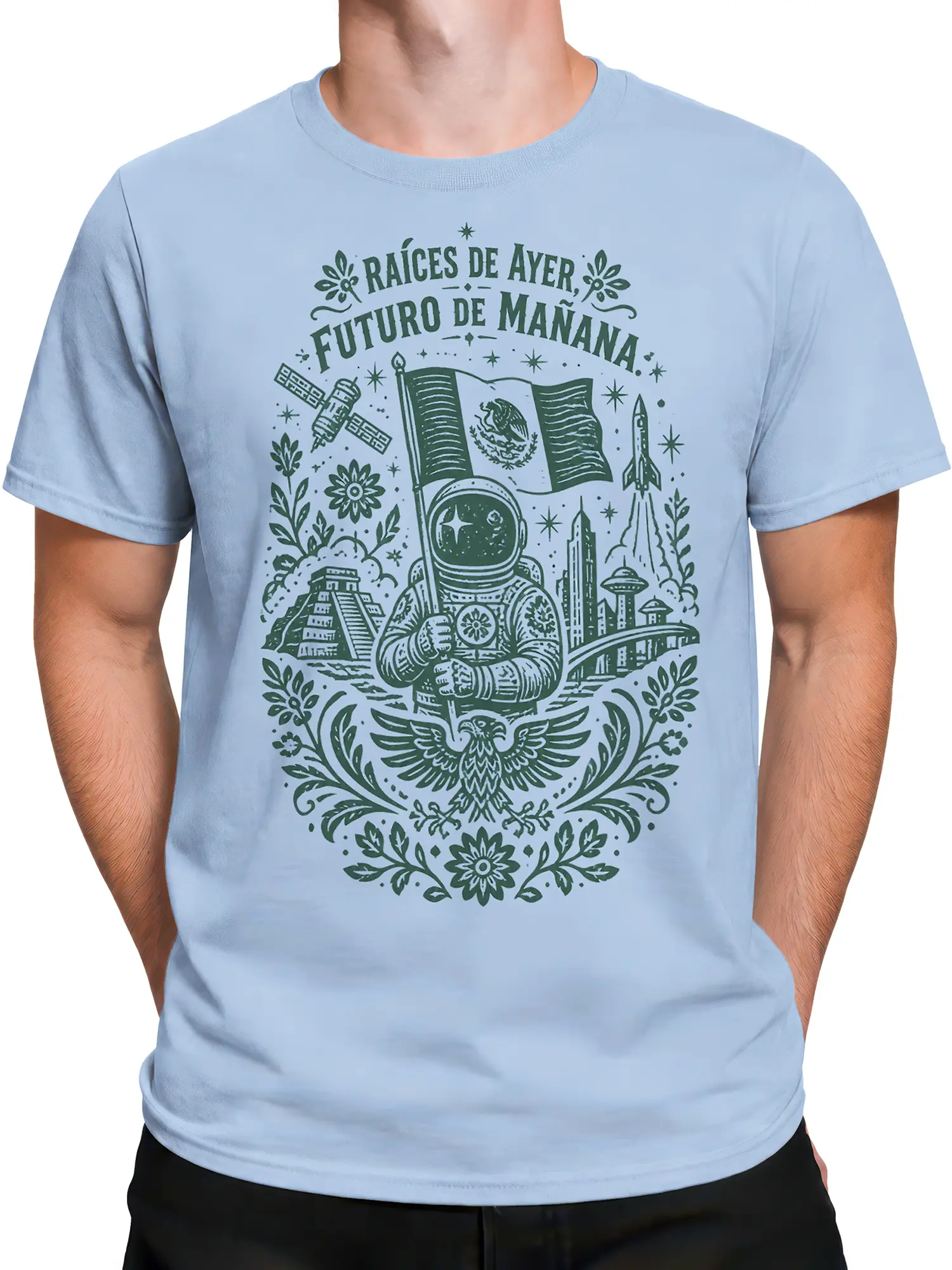 Male torso wearing a light blue Mexican space T-shirt with astronaut, rocket, satellite, pyramid, and eagle artwork