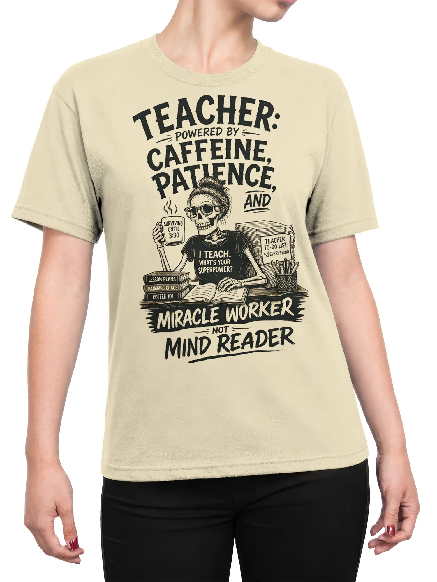 Female torso wearing a beige skeleton teacher T-shirt with coffee, lesson plans, and “Miracle Worker” lettering