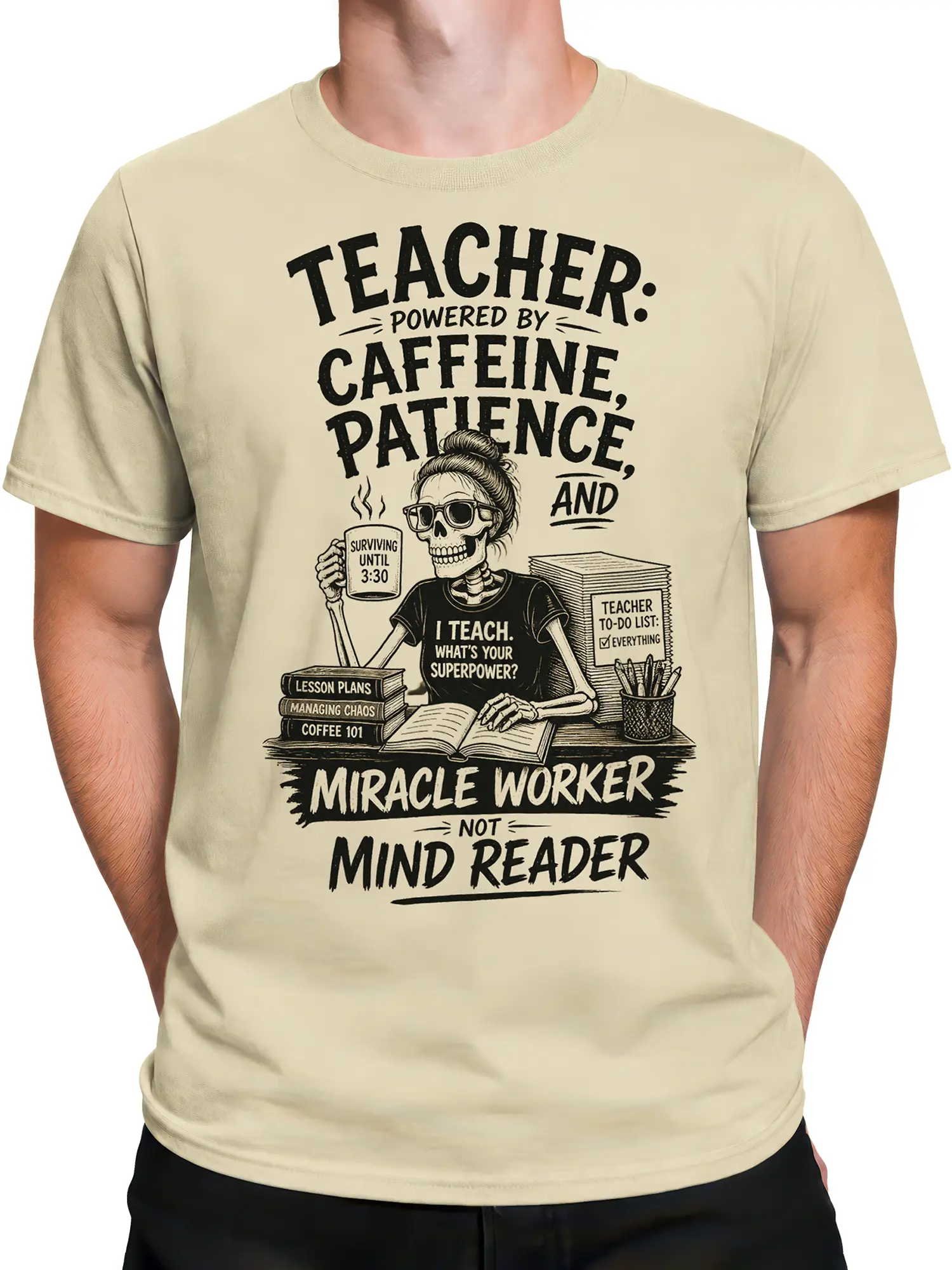 Male torso wearing a beige teacher graphic tee with skeleton educator, books, coffee, and classroom humor