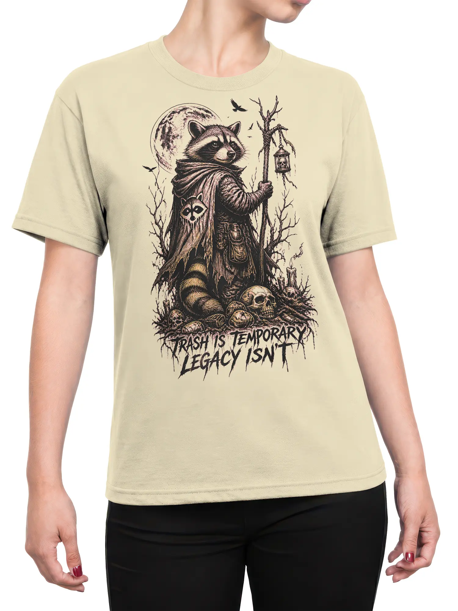 Female torso wearing a beige T-shirt with a cloaked raccoon lantern design and dark fantasy legacy message