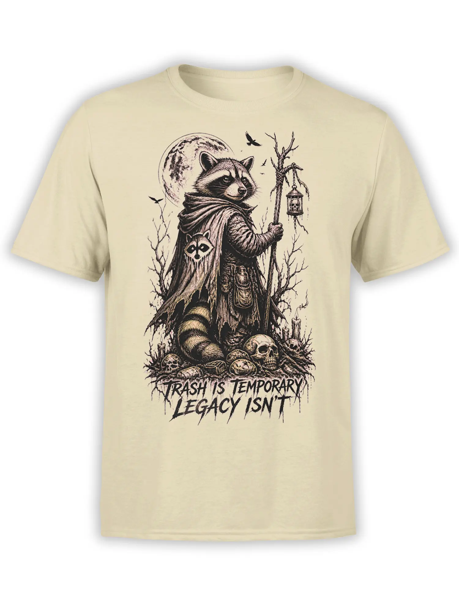 Beige T-shirt featuring a cloaked raccoon with a lantern, moon, skulls, ravens, and a dark legacy message