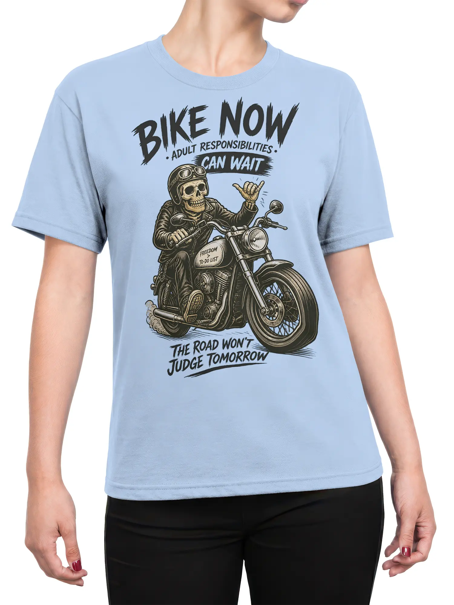 Female torso wearing a light blue skeleton biker motorcycle T-shirt with bold road-themed lettering