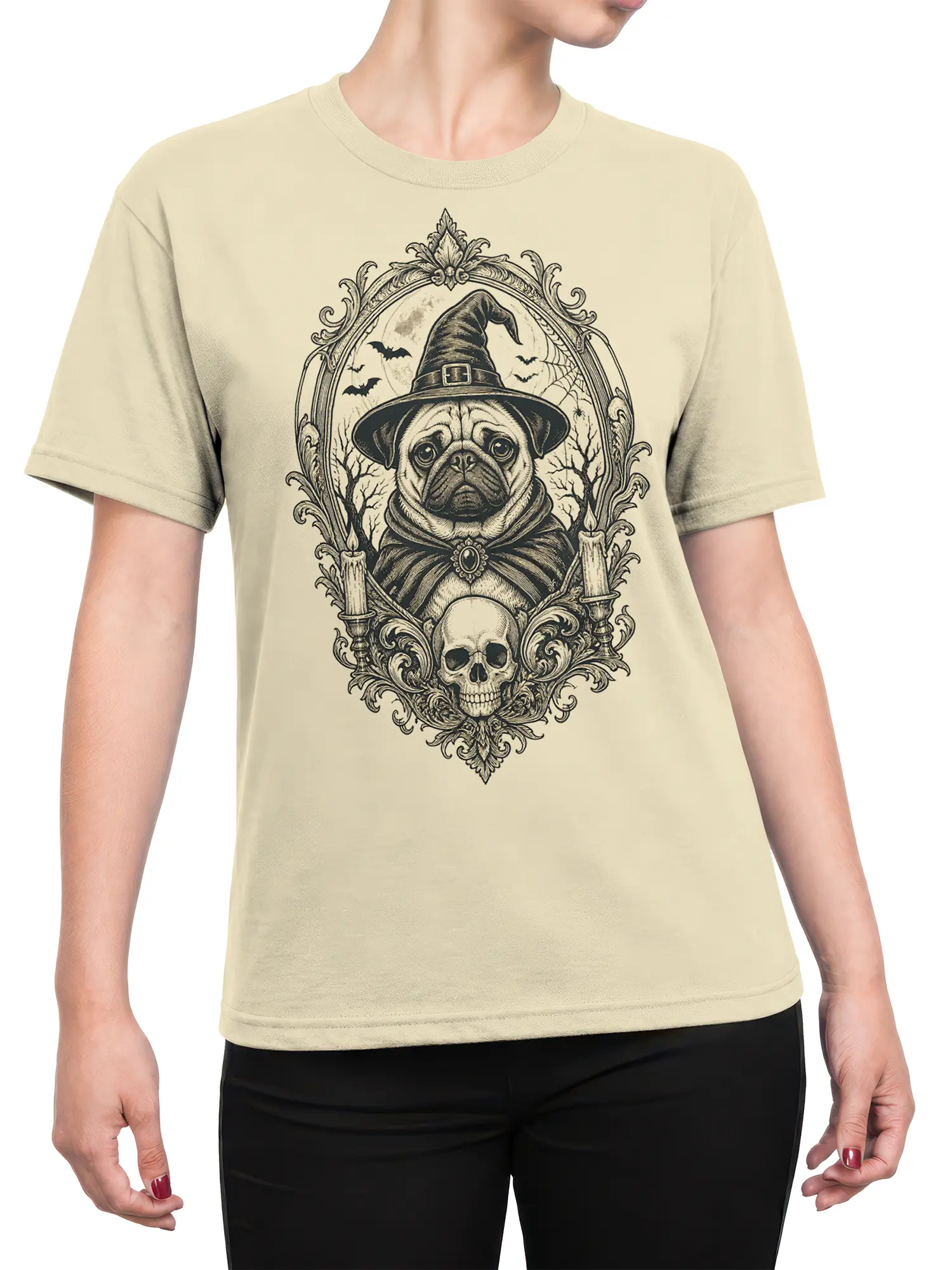 Female torso wearing a beige T-shirt with a gothic pug in a witch hat, bats, candles, and skull design