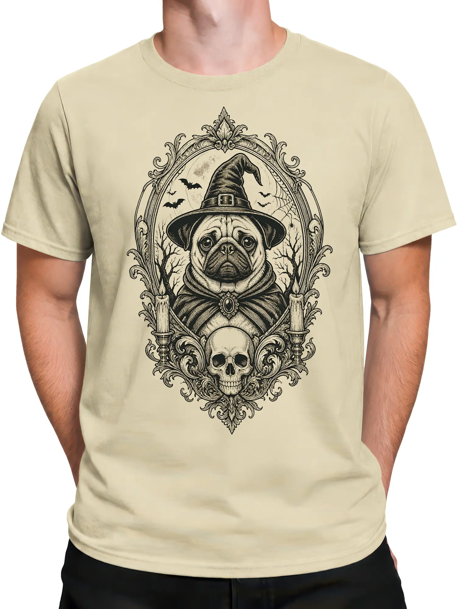 Male torso wearing a beige T-shirt with a detailed witch pug dog, bats, candles, and skull artwork