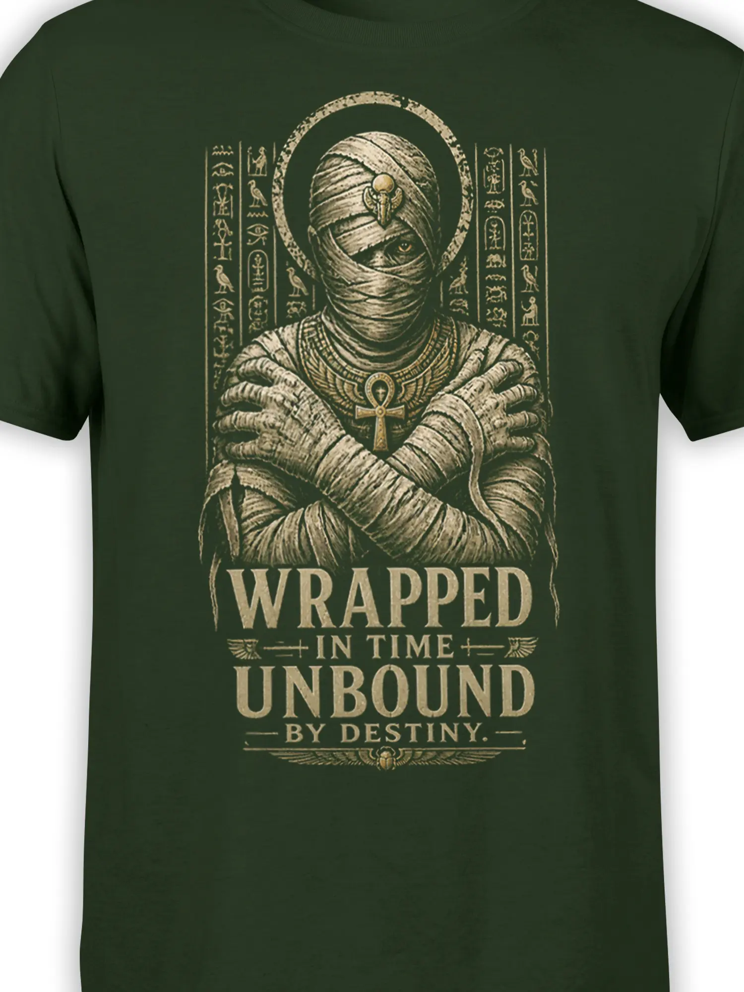 Close-up of Egyptian mummy artwork, ankh, hieroglyphs, and vintage lettering on dark green fabric