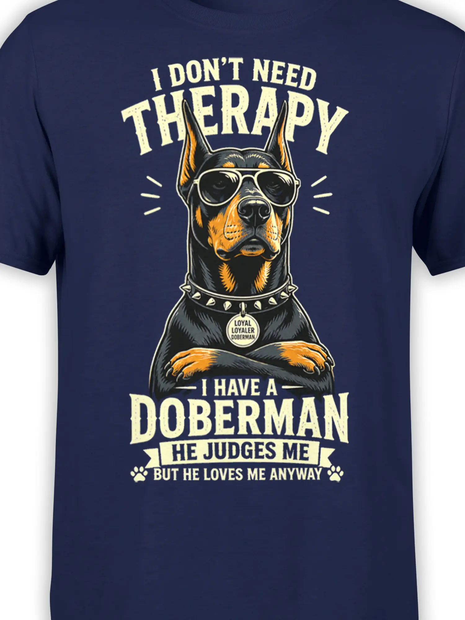 Close-up of Doberman sunglasses, spiked collar, and loyal dog humor graphic on a navy shirt