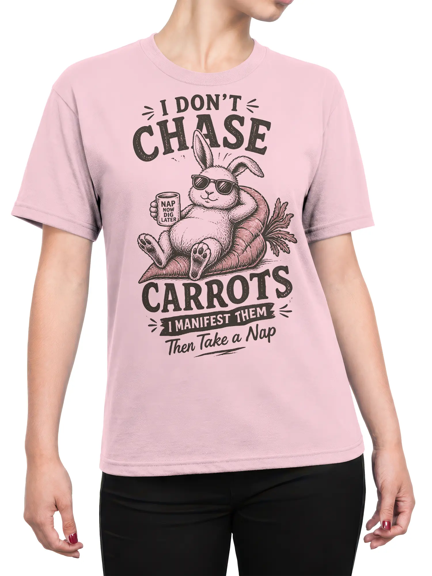 Female torso wearing a pink rabbit shirt with sunglasses, carrots, and a playful nap message