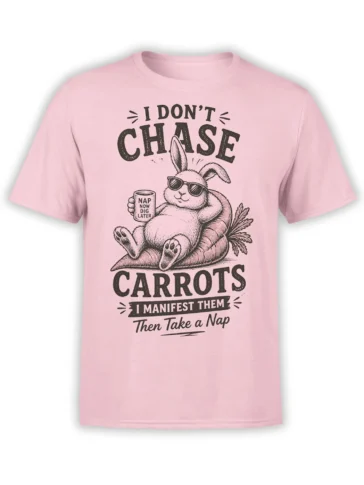 Pink shirt with a relaxed rabbit in sunglasses lounging on carrots and holding a nap-themed mug