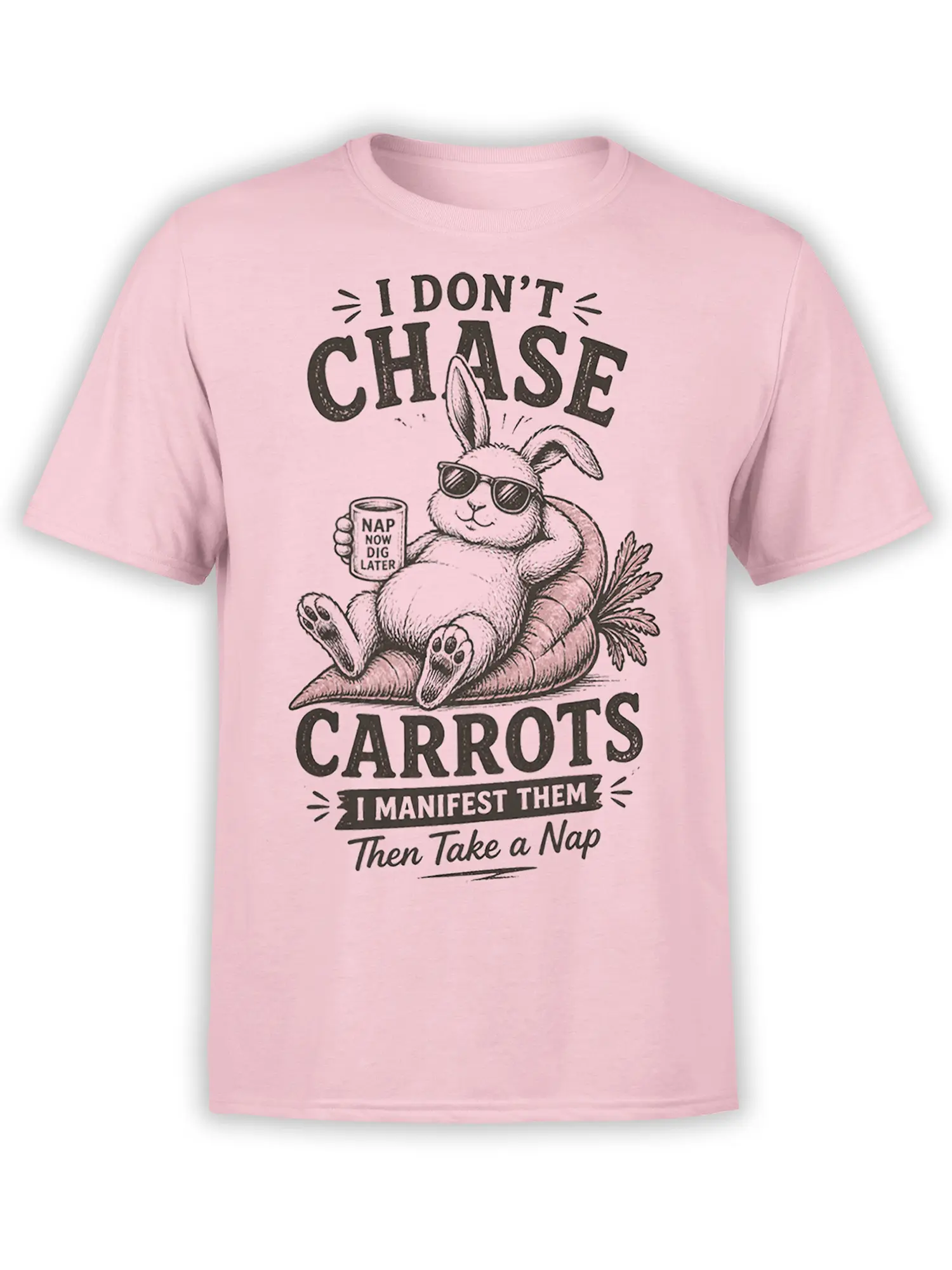 Pink shirt with a relaxed rabbit in sunglasses lounging on carrots and holding a nap-themed mug