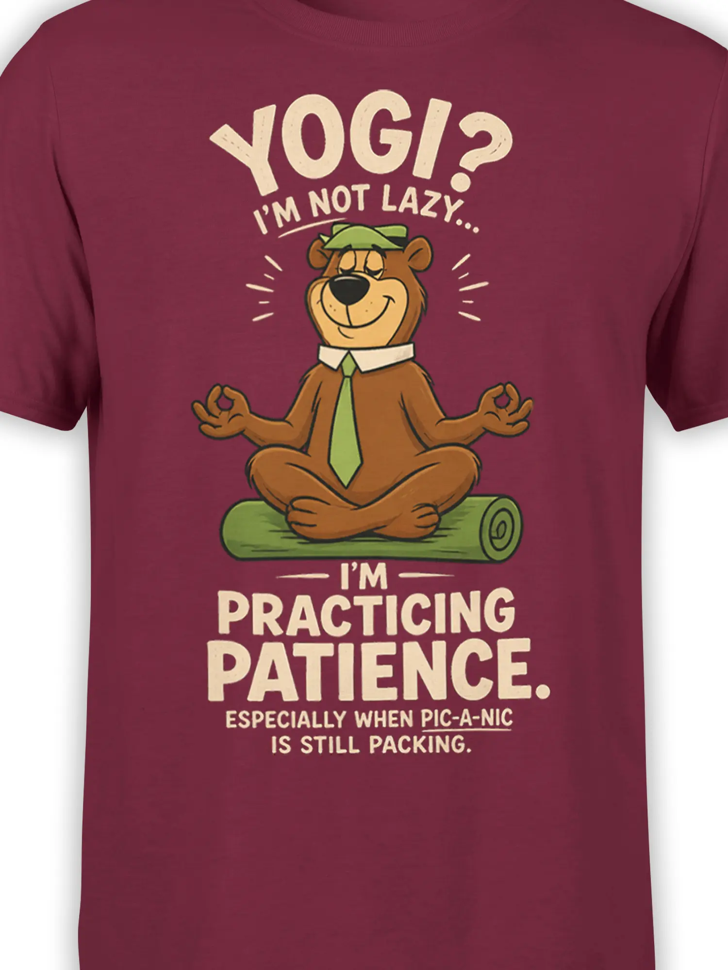 Close-up of the meditating brown bear and picnic patience lettering printed on a burgundy T-shirt