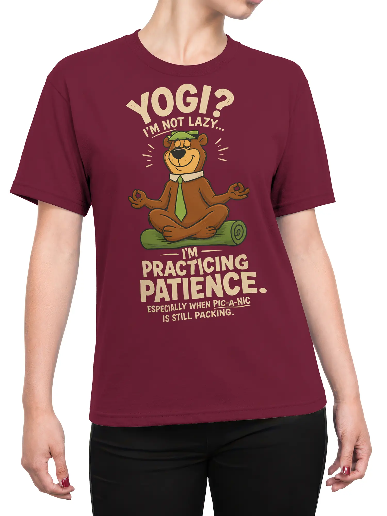 Female torso wearing a burgundy T-shirt with a meditating cartoon bear and funny picnic patience design
