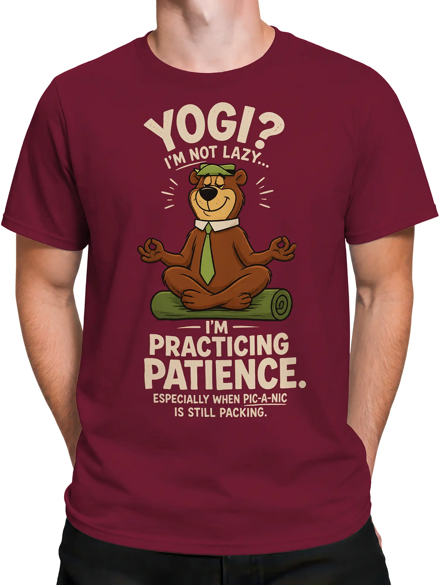 Male torso wearing a burgundy T-shirt with a cartoon bear practicing patience for a picnic