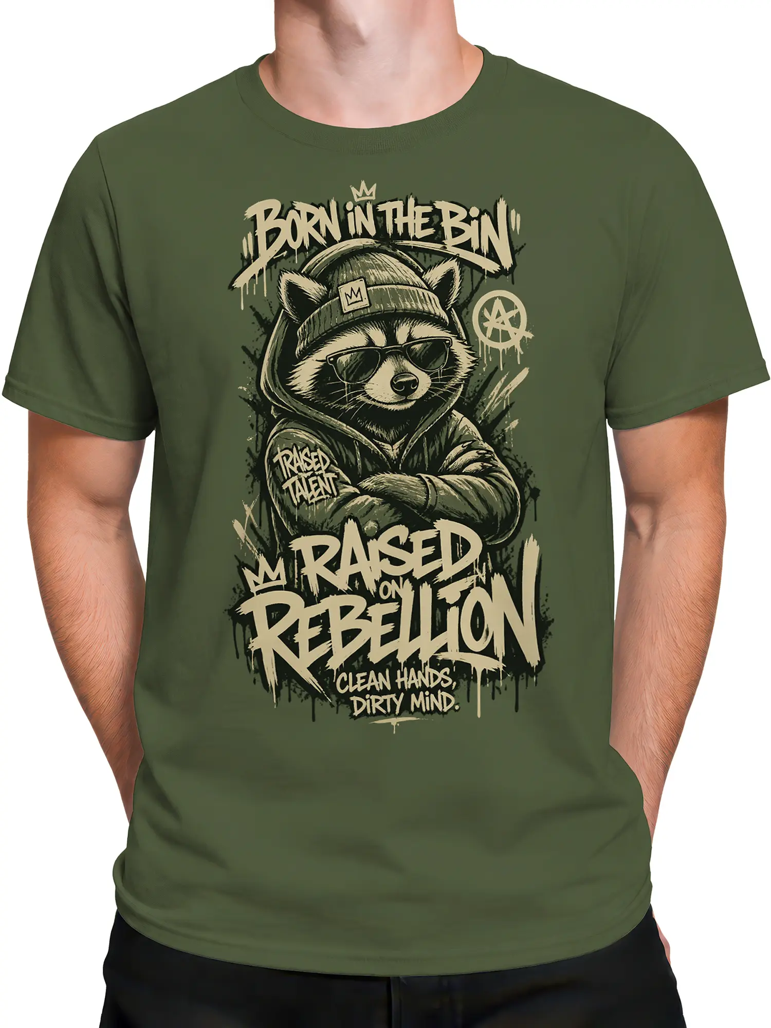 Male model wearing green raccoon t-shirt with crowned character, hoodie, sunglasses, and bold streetwear lettering