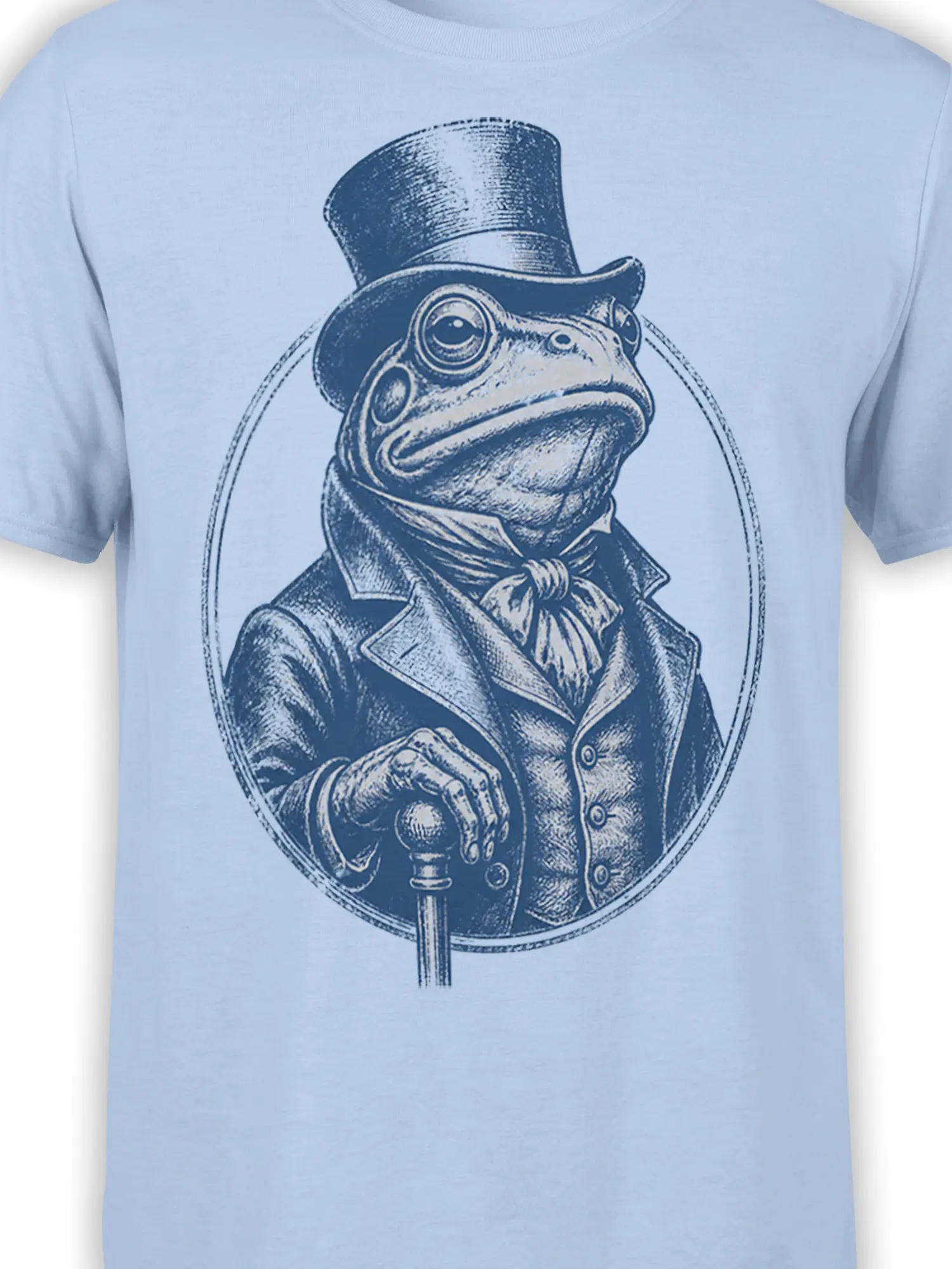 Close-up of the dapper frog gentleman design on a light blue shirt, showing the top hat, bow tie, scarf, coat, and cane
