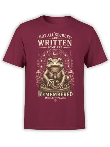 Mystical frog holding a moon crystal on a maroon shirt with mushrooms and celestial symbols