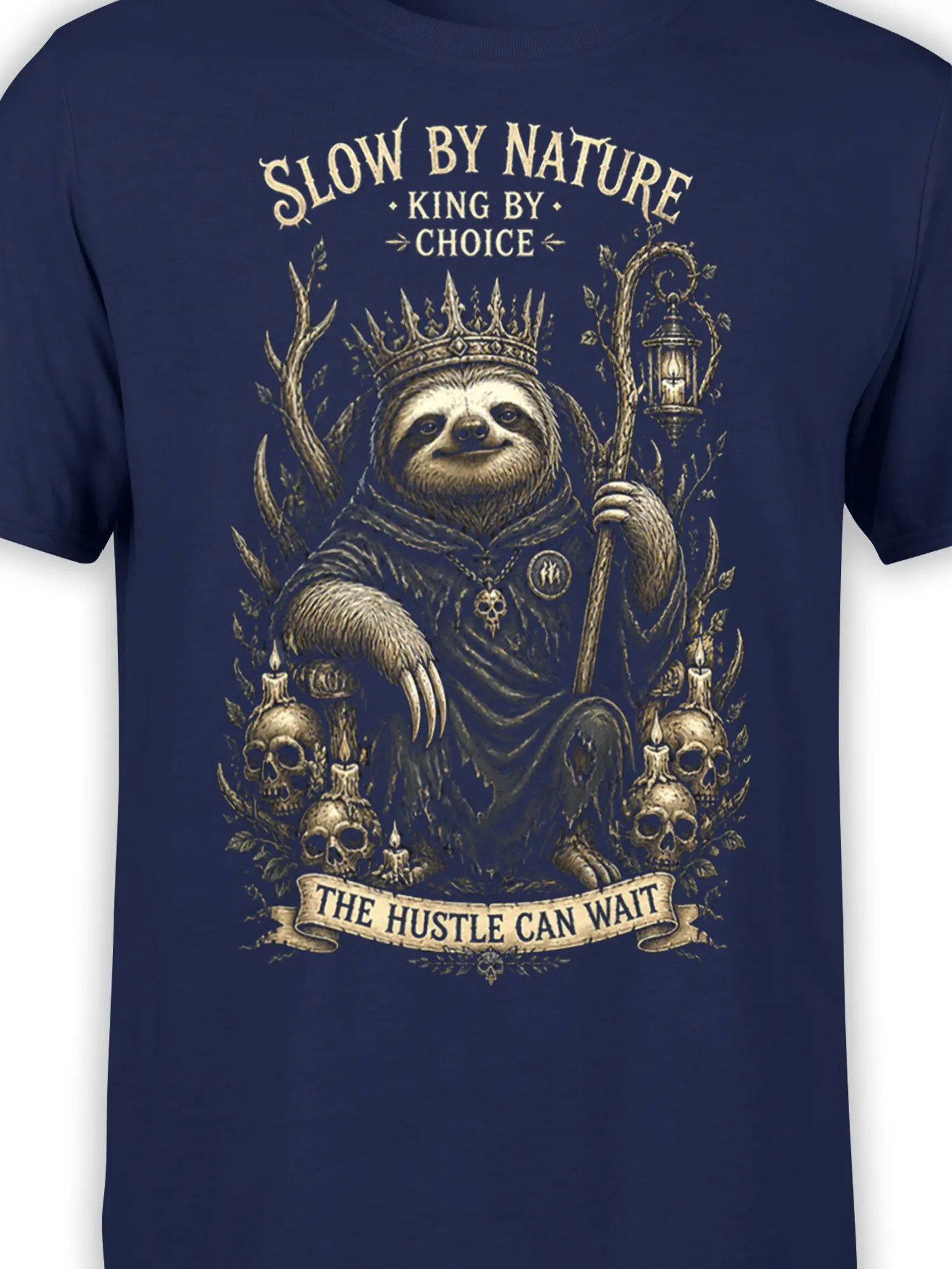 Close-up of crowned sloth artwork with staff, lantern, skulls, and vintage lettering on navy fabric