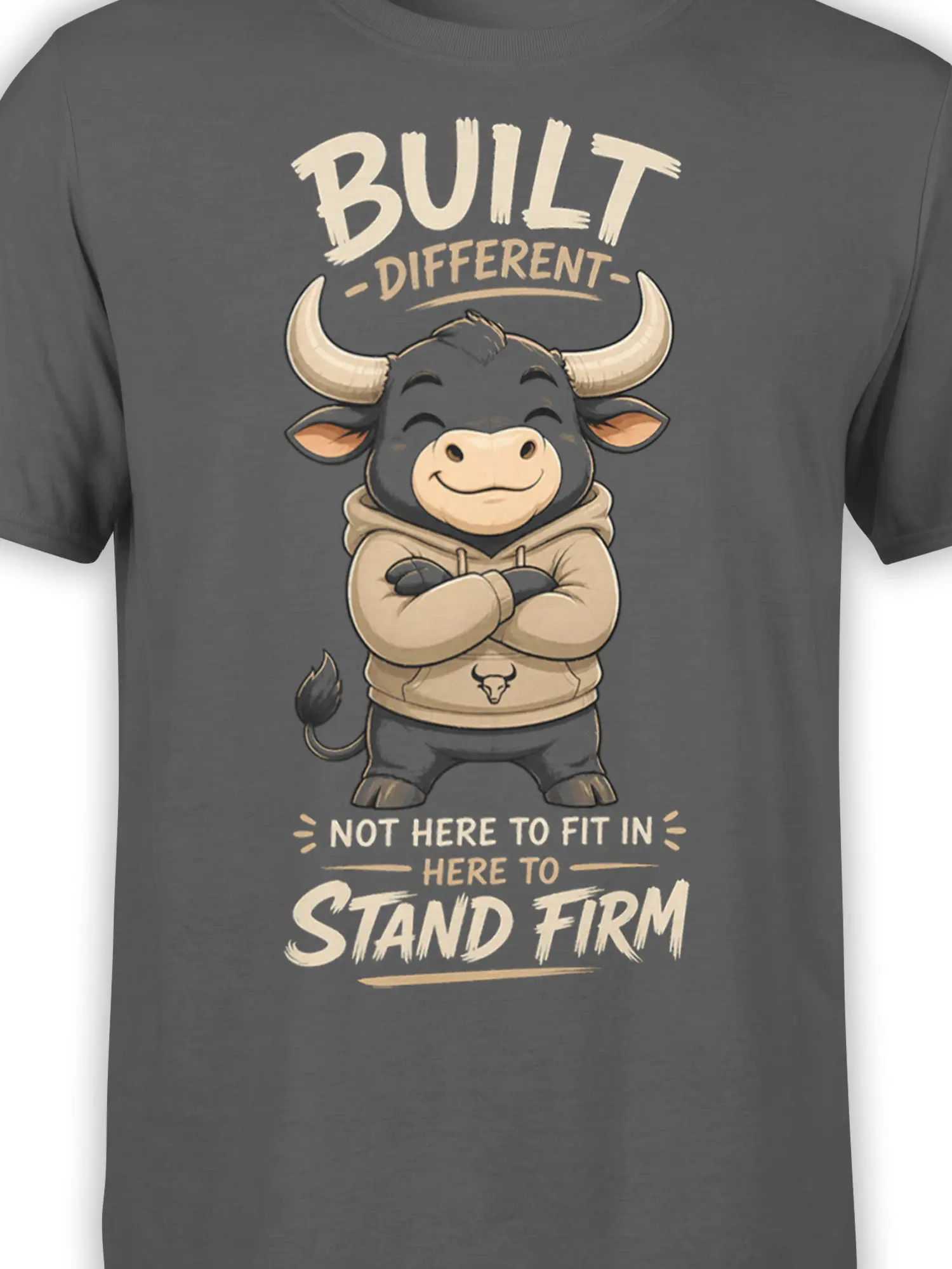 Close-up of cartoon bull artwork and Built Different Stand Firm message on gray fabric