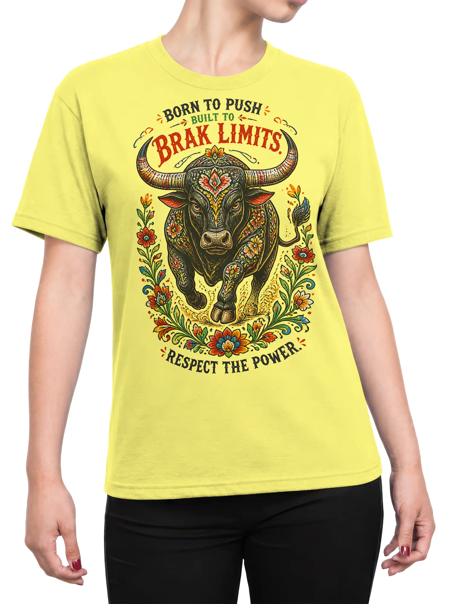 Female torso wearing a yellow T-shirt with an ornate floral bull and motivational power message