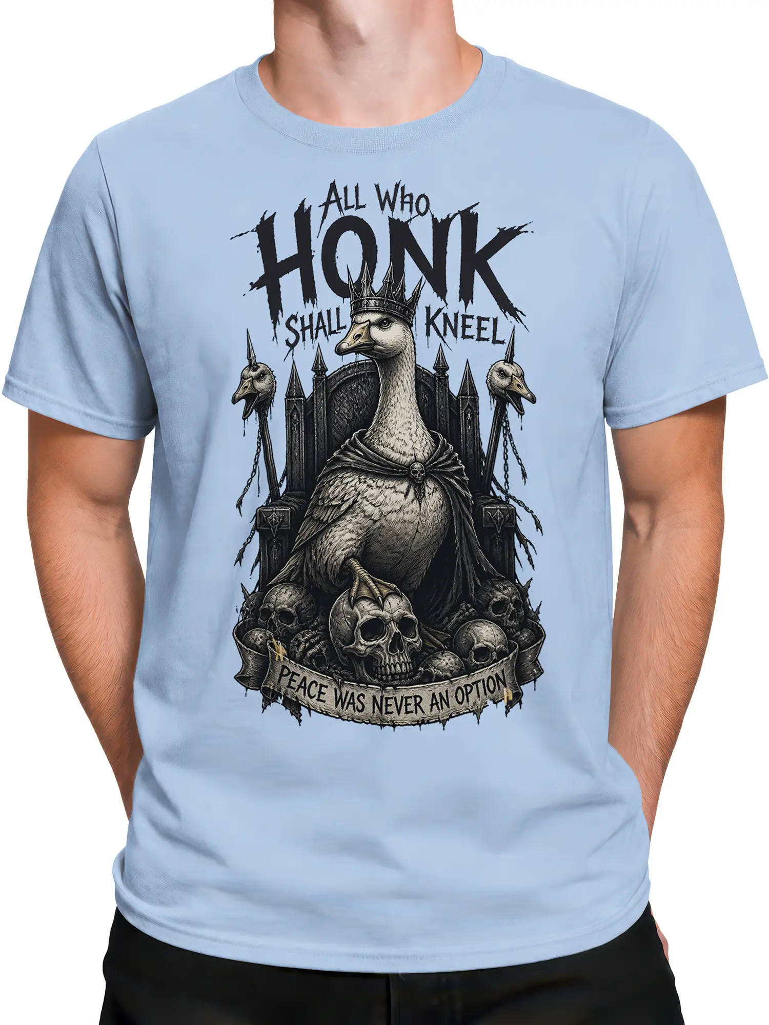 Male torso wearing a light blue goose graphic shirt with crowned bird, skulls, chains, and gothic lettering