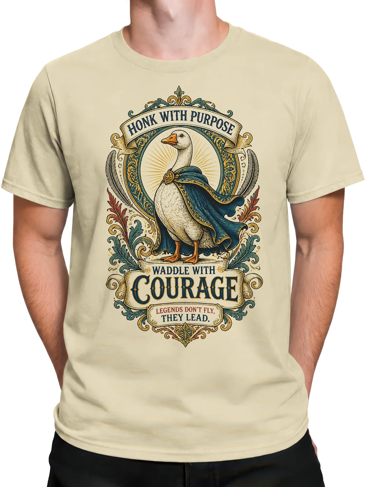 Male torso wearing a beige vintage goose T-shirt with a blue cape and ornate heroic crest design