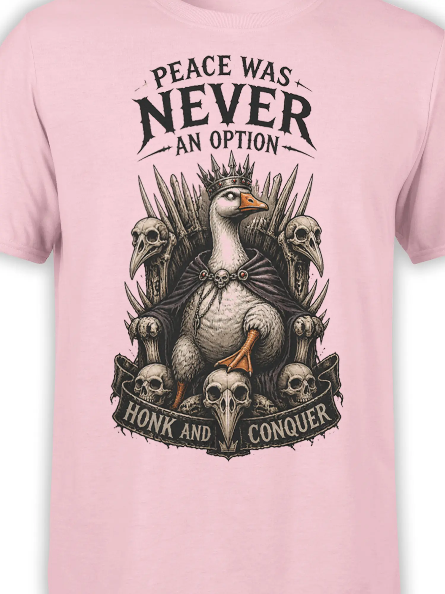Close-up of crowned bird, skull throne, and Honk and Conquer artwork on a pink T-shirt