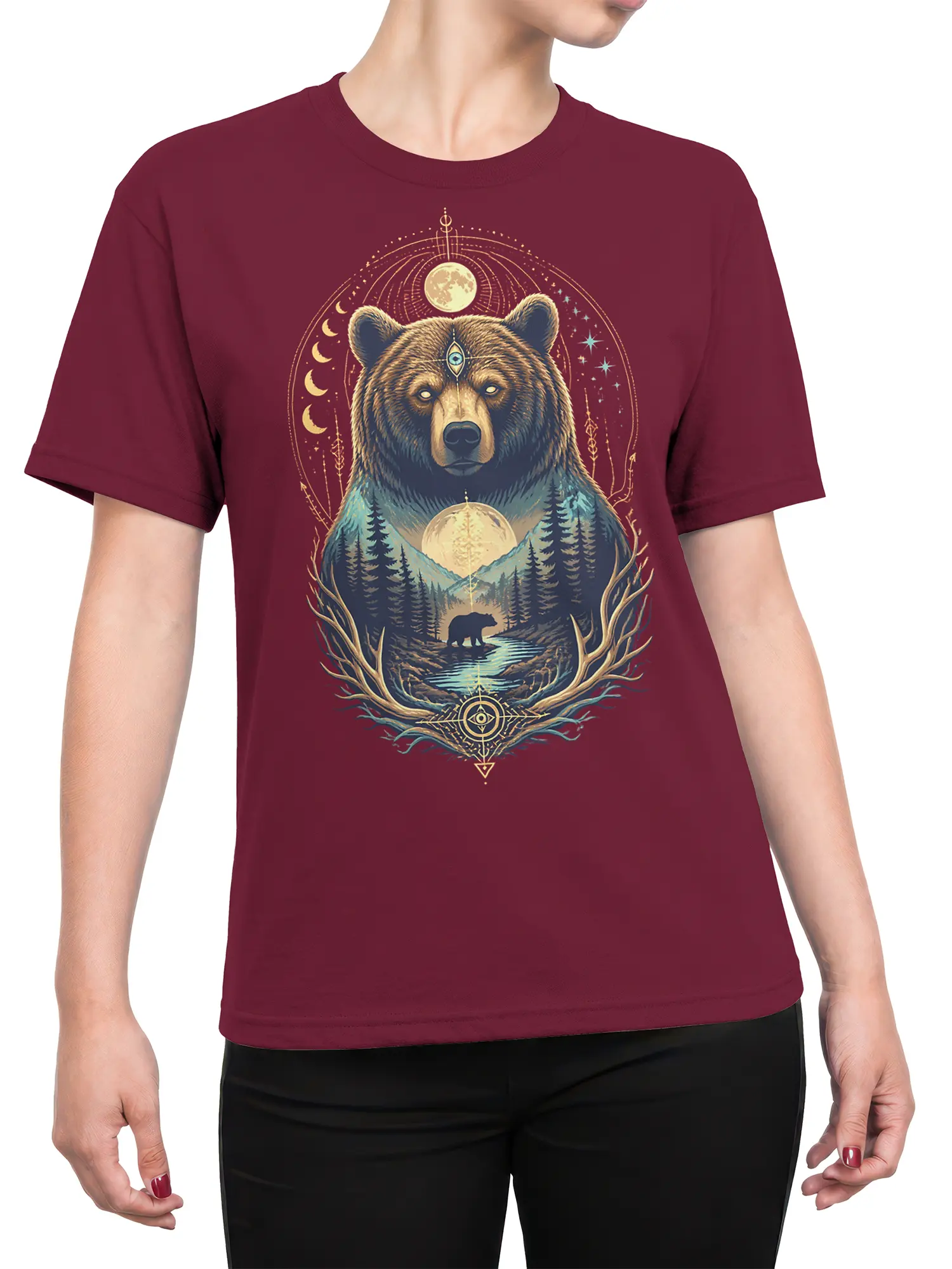 Female torso wearing a burgundy bear T-shirt with moon phases, mountains, evergreen trees, and mystical forest artwork
