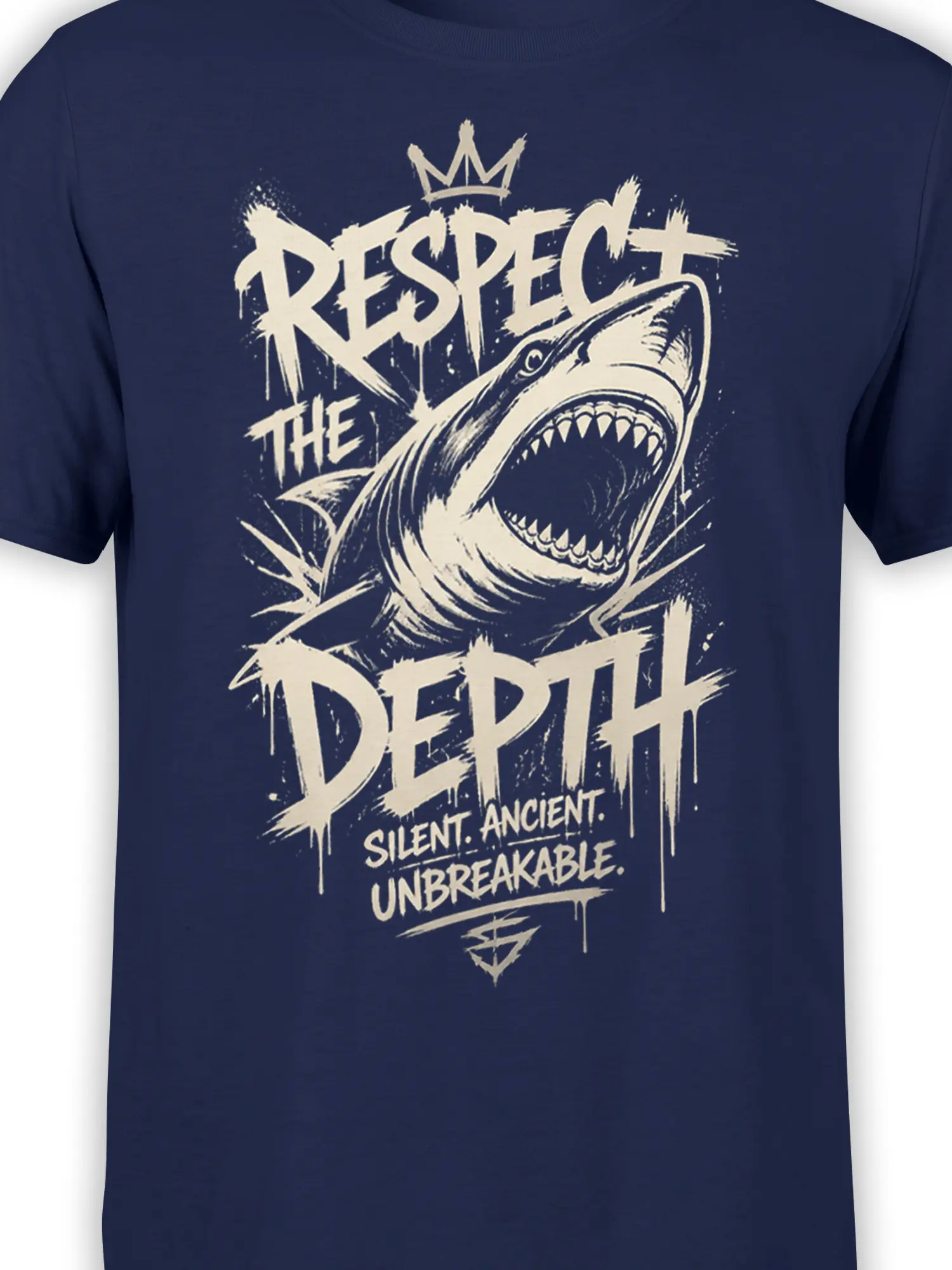 Close-up of crowned shark artwork and distressed “Respect the Depth” text on navy fabric