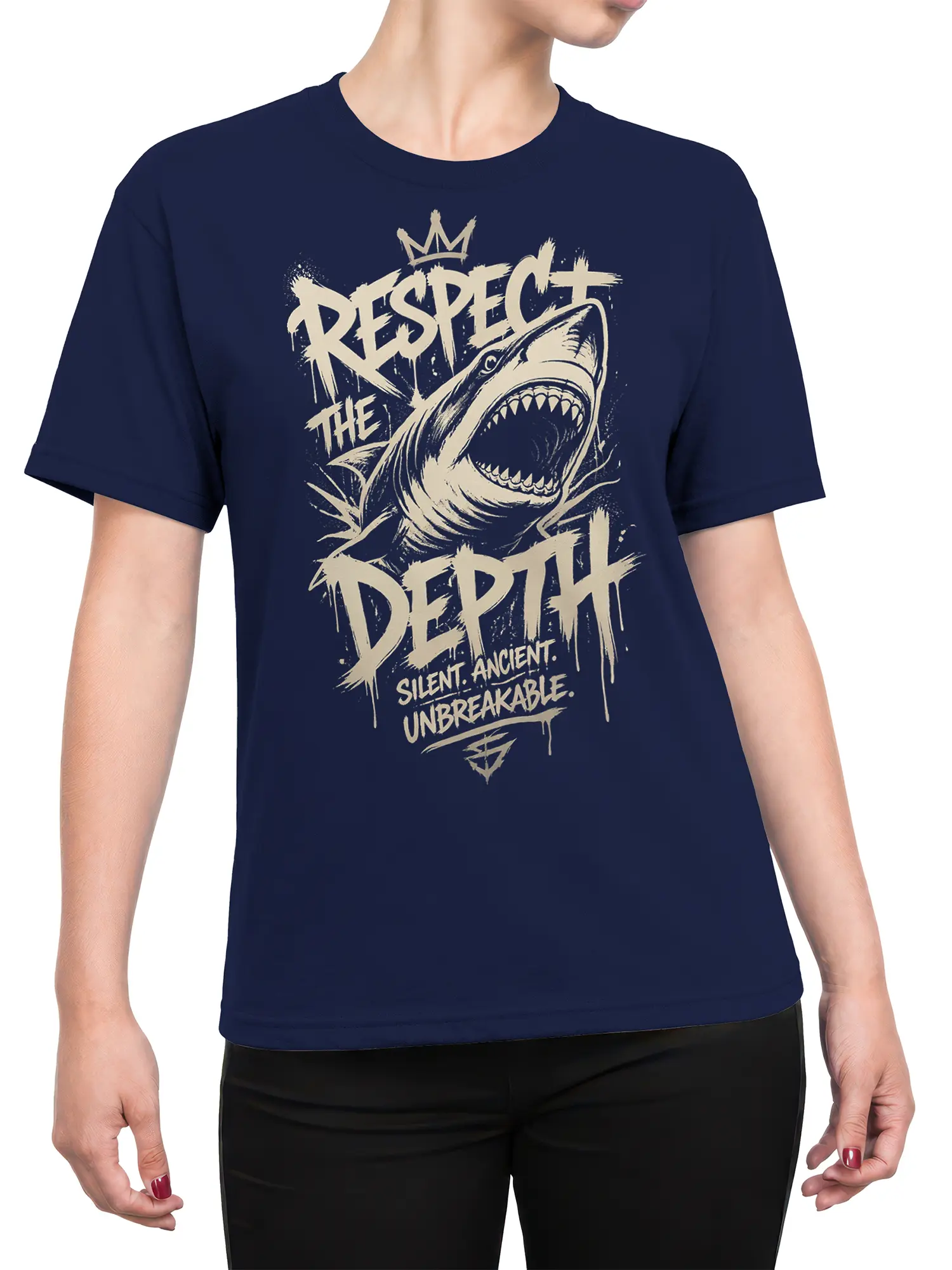 Female torso wearing a navy T-shirt with a crowned shark and bold ocean-themed lettering