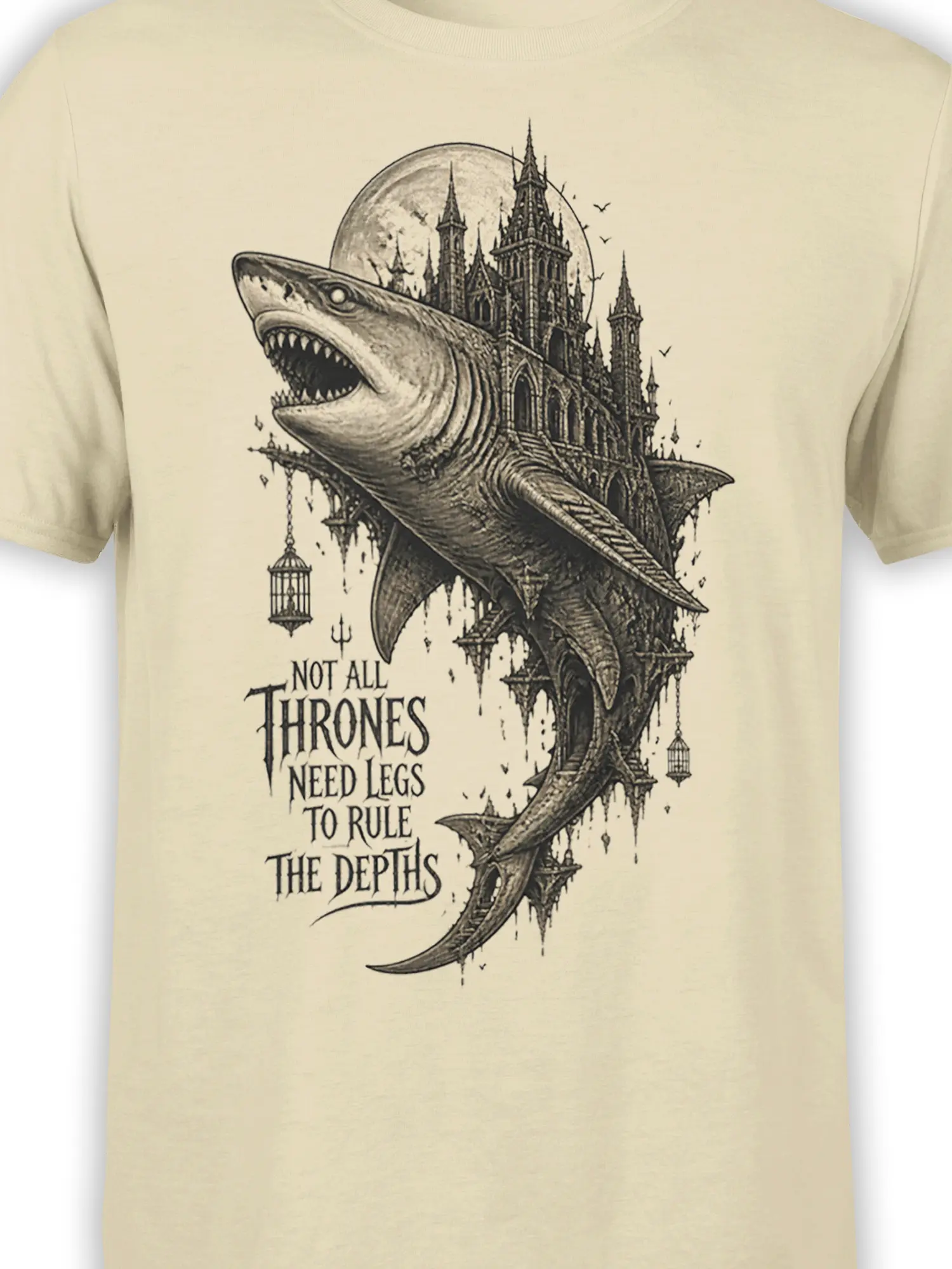 Close-up of the shark and gothic castle artwork printed on a beige fantasy graphic T-shirt