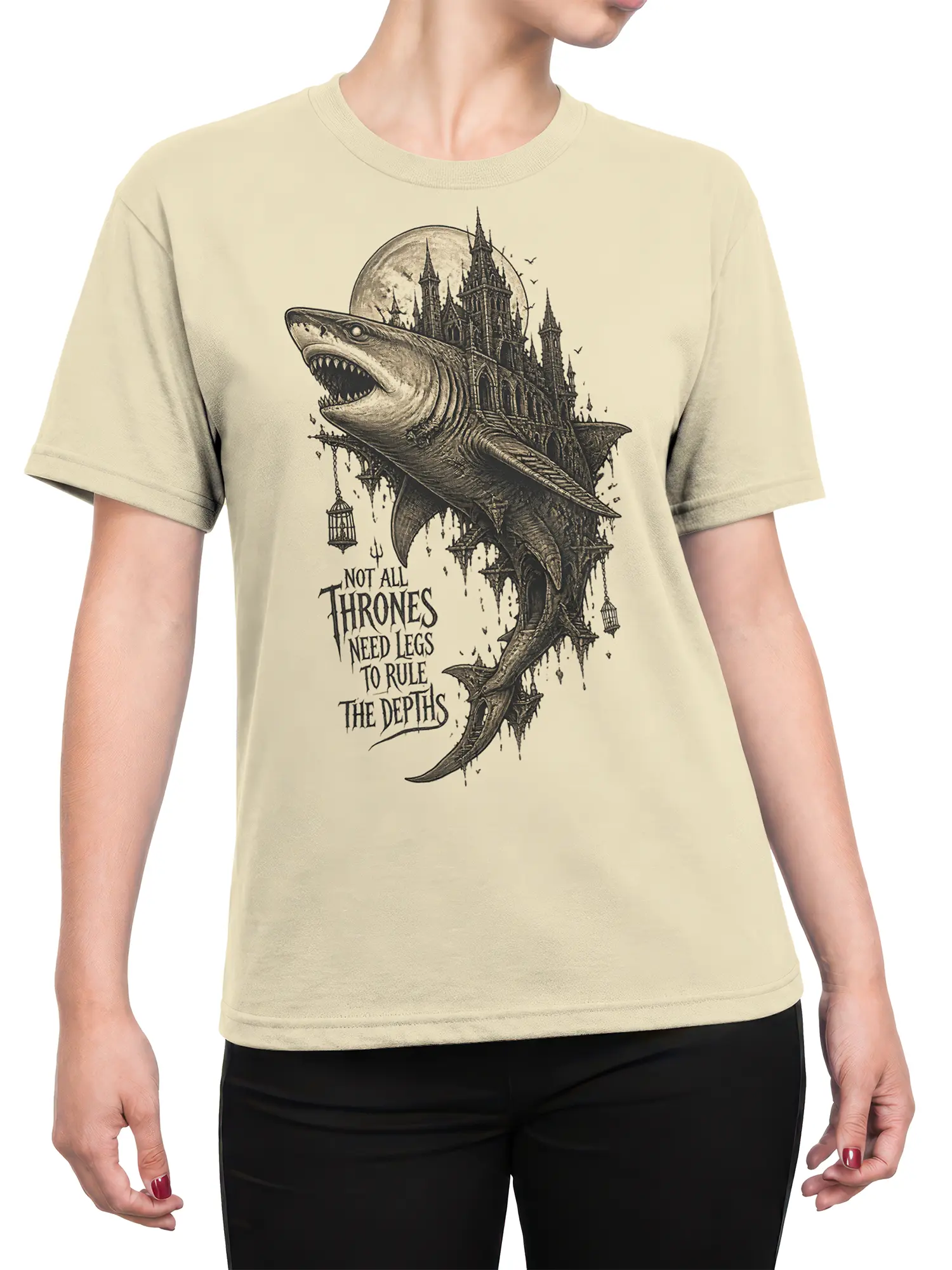 Female torso wearing a beige shark graphic T-shirt with a gothic castle and moonlit fantasy artwork