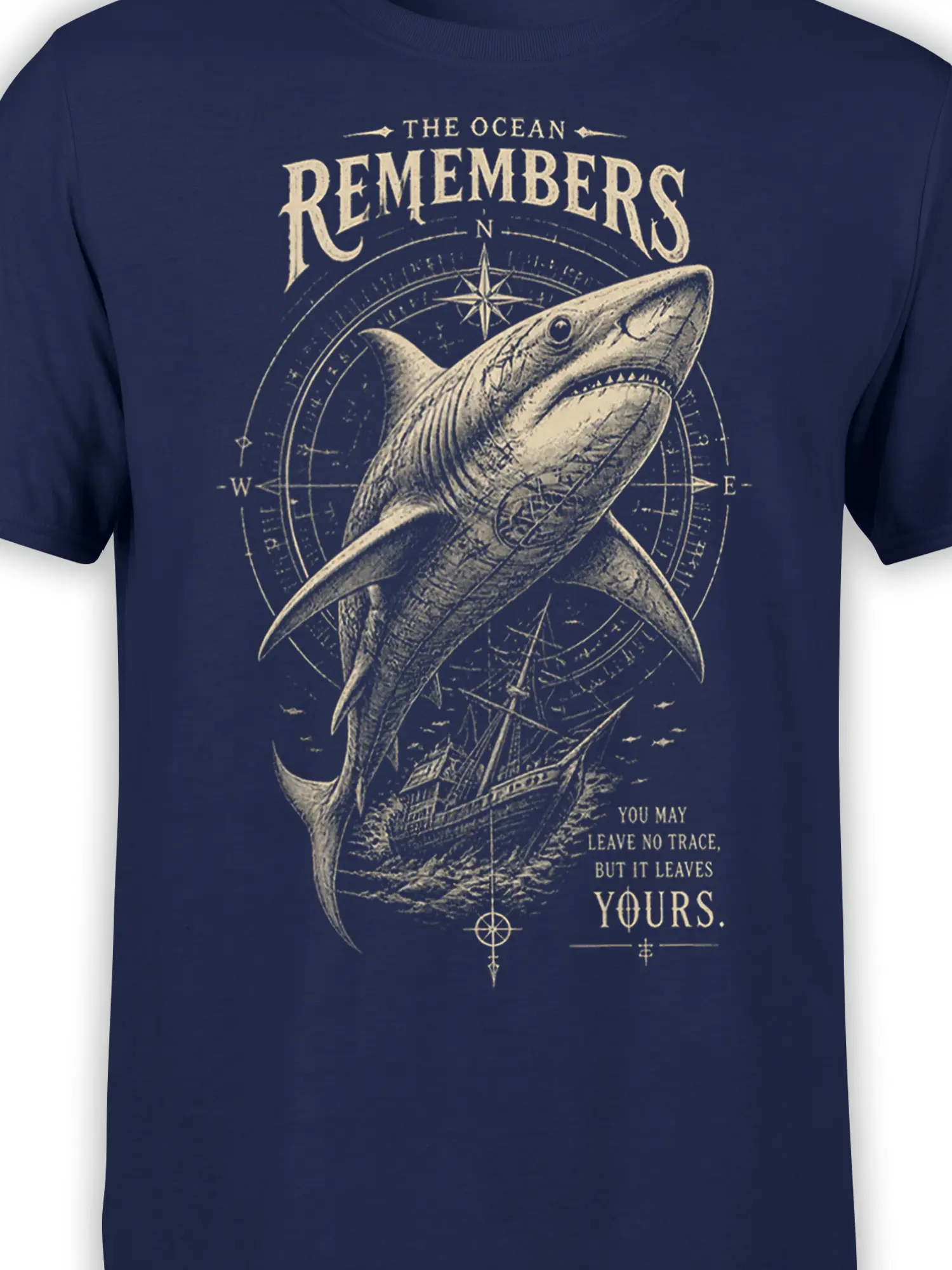 Close-up of cream shark and compass artwork on the navy Ocean Remembers T-shirt