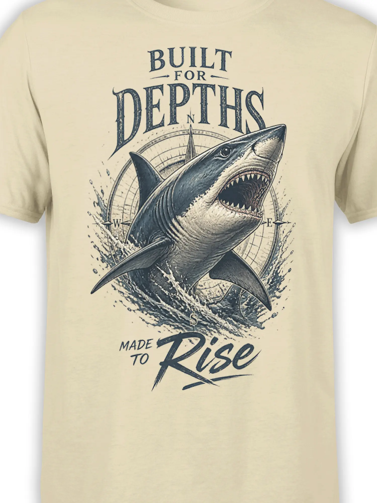 Close-up of the vintage shark and compass design printed on a beige T-shirt