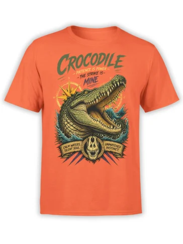 Orange crocodile T-shirt with open jaws, compass artwork, skull emblem, and bold vintage lettering