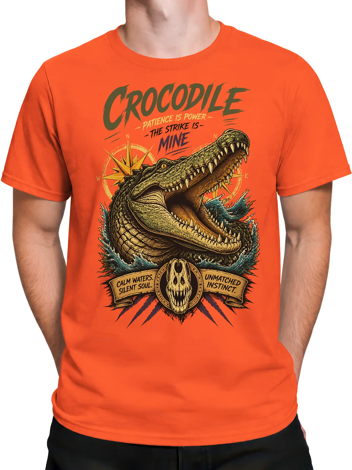 Male torso wearing an orange crocodile T-shirt with vintage predator artwork, compass, skull emblem, and water