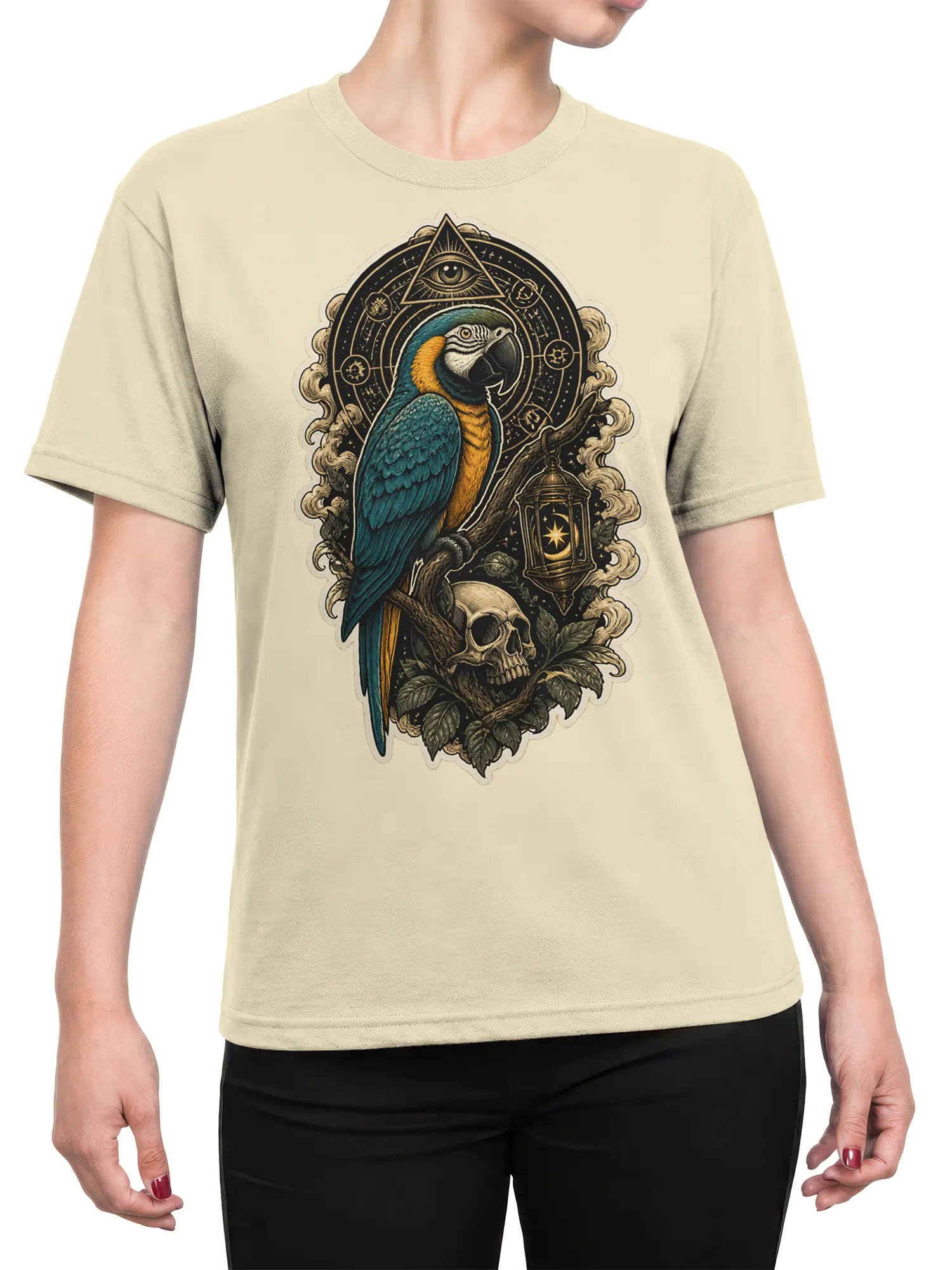 Female torso wearing a beige T-shirt with a mystical parrot, skull, lantern, and cosmic eye design