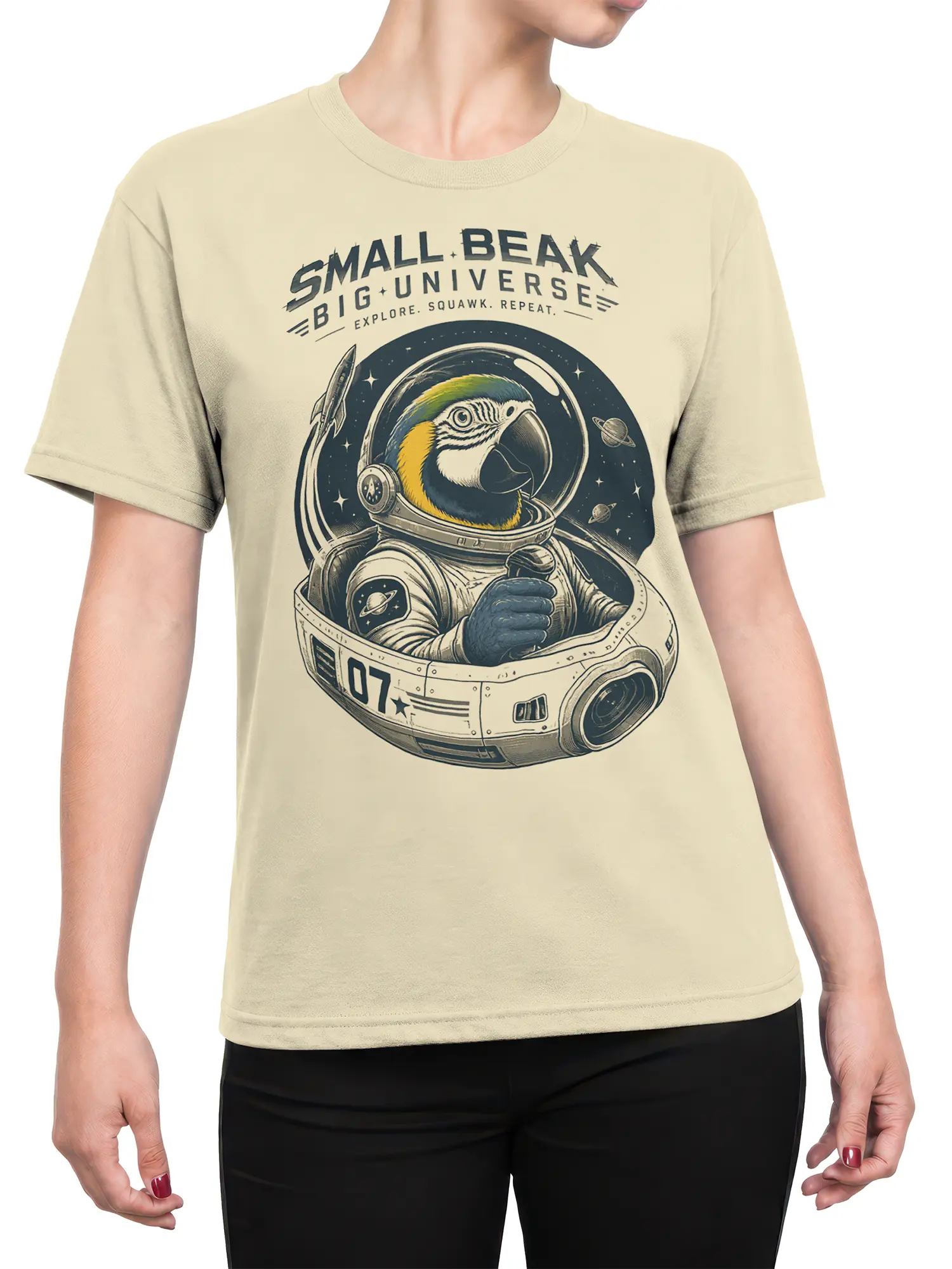 Female torso wearing a beige parrot astronaut T-shirt with a detailed cosmic spacecraft design