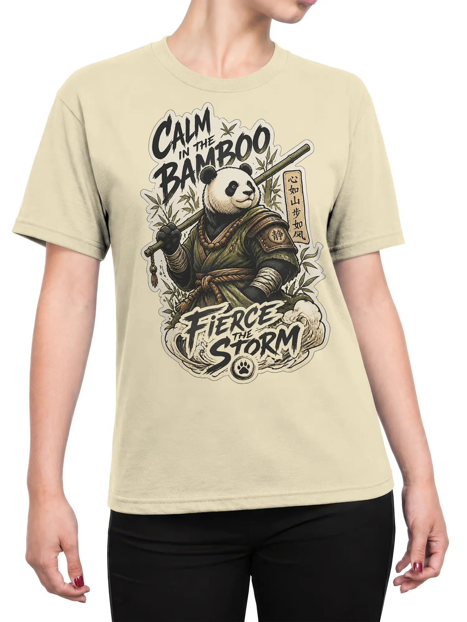 Female torso wearing a beige panda warrior T-shirt with bamboo artwork, storm lettering, and a vintage illustrated design