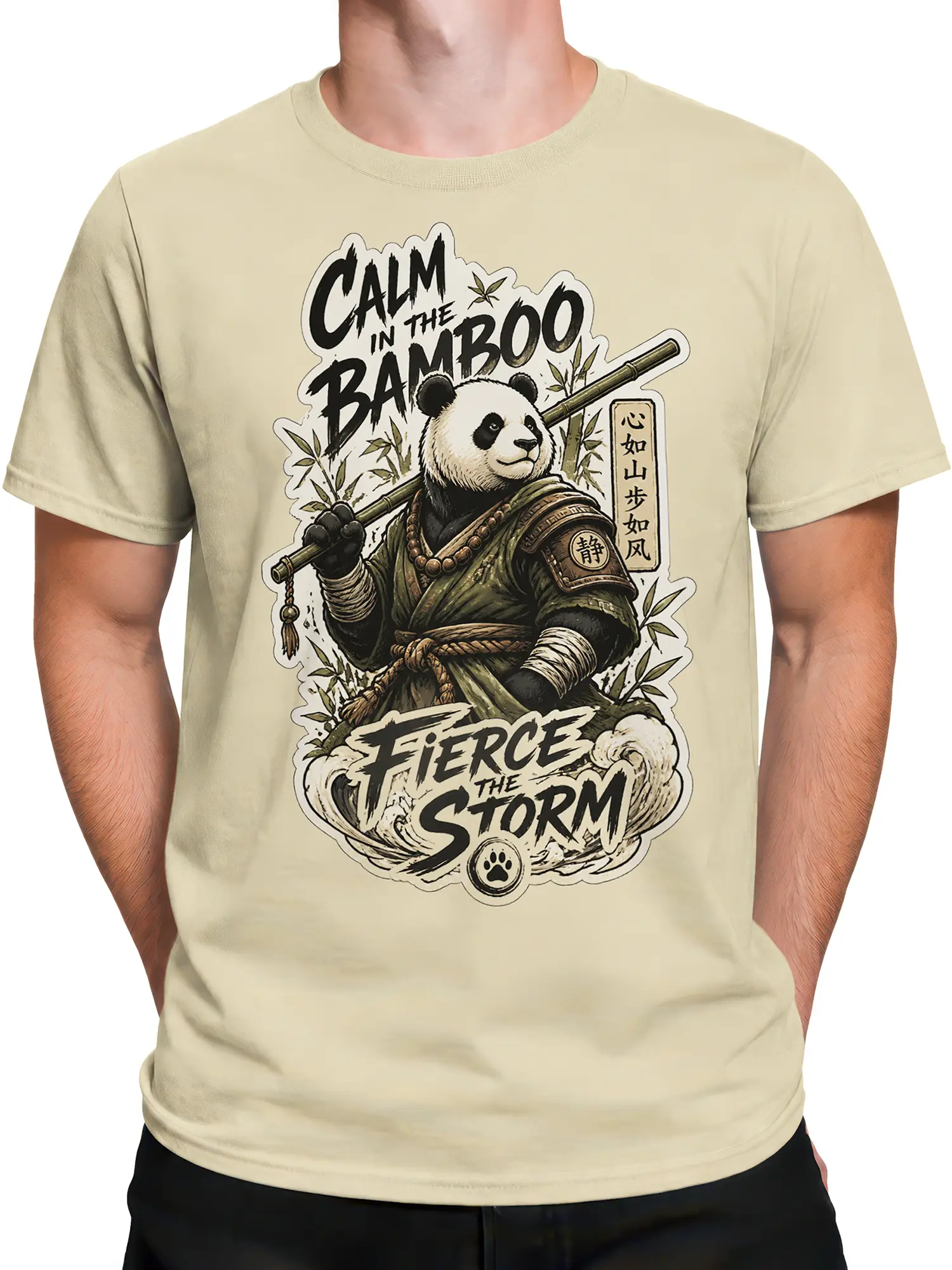Male torso wearing a beige panda warrior T-shirt with bamboo staff artwork and bold storm lettering