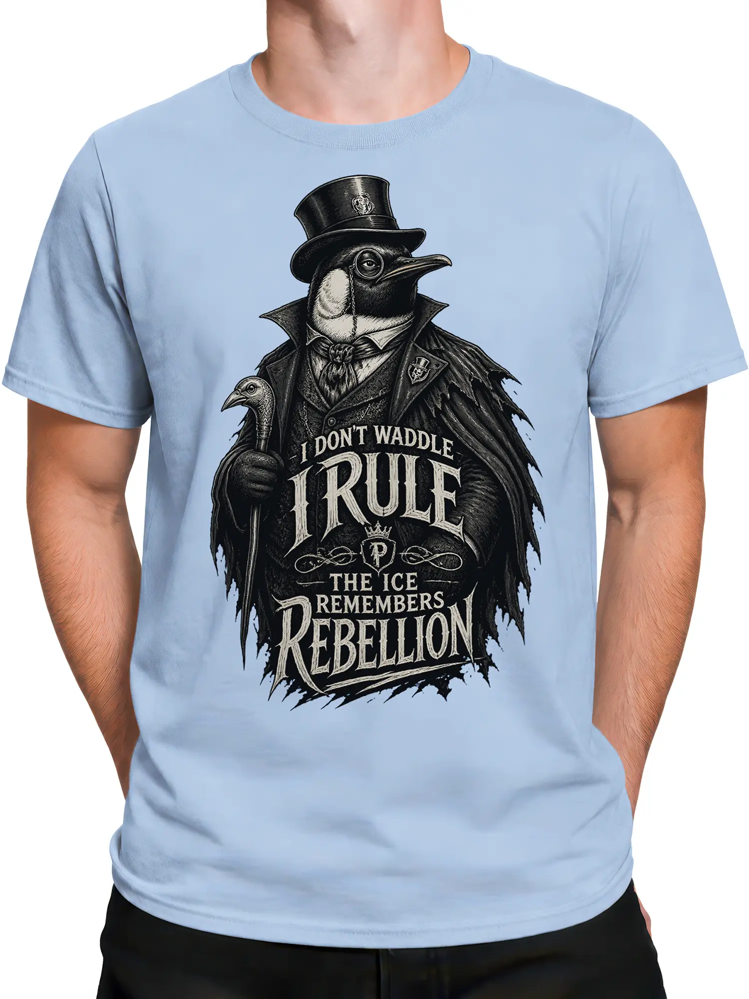 Male torso wearing a light blue T-shirt with a top-hatted penguin and gothic rebellion graphic