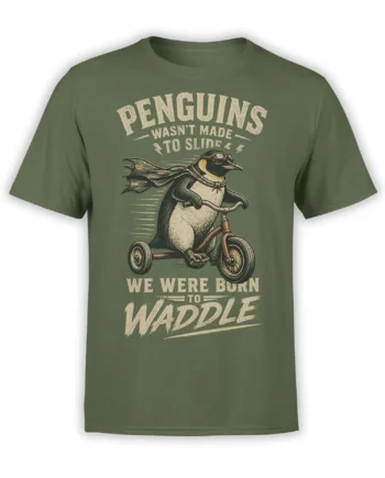 Green penguin T-shirt with a caped penguin riding a tricycle and bold cream lettering about waddling